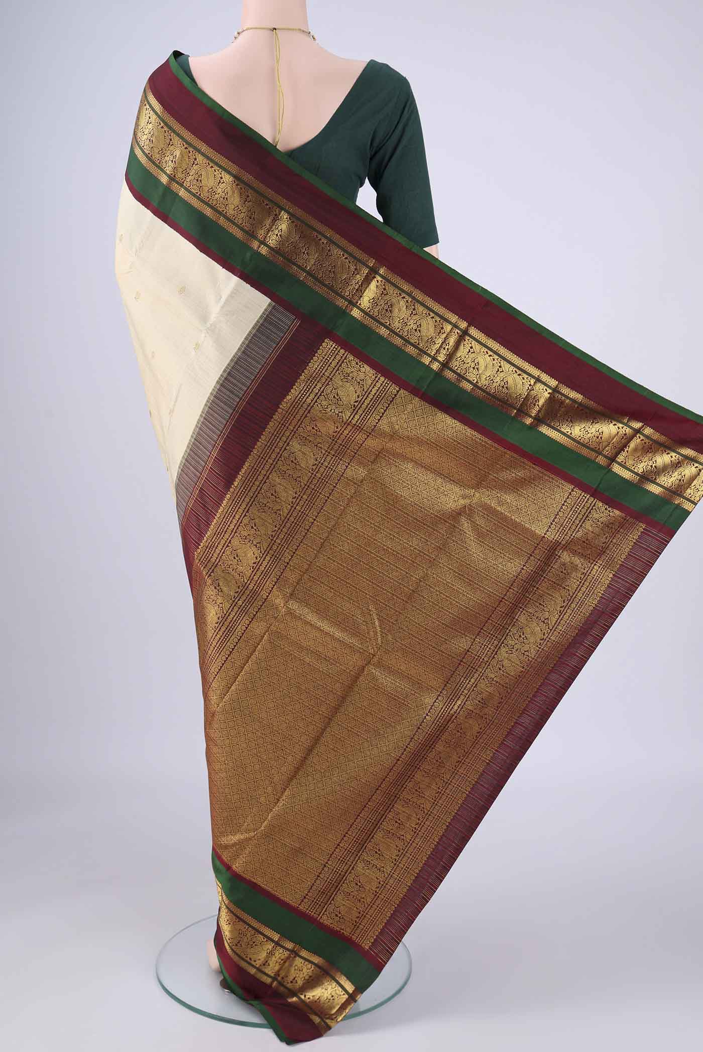 Flat view of Cream Kanchipuram Silk Saree with Zari Butta on the body and Zari Border. 