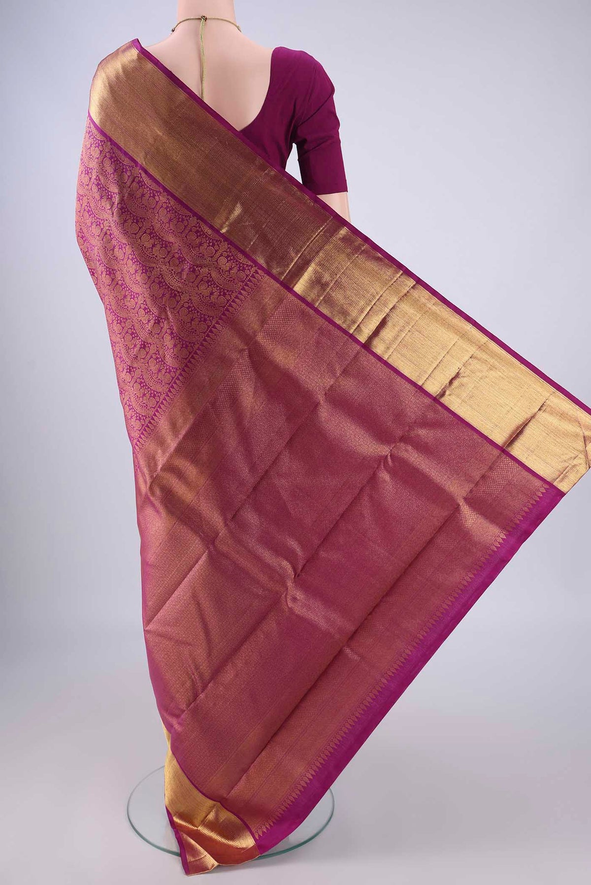 Flat view of Magenta Kanchipuram Silk Saree with Zari Brocade on the body and Zari Border. 