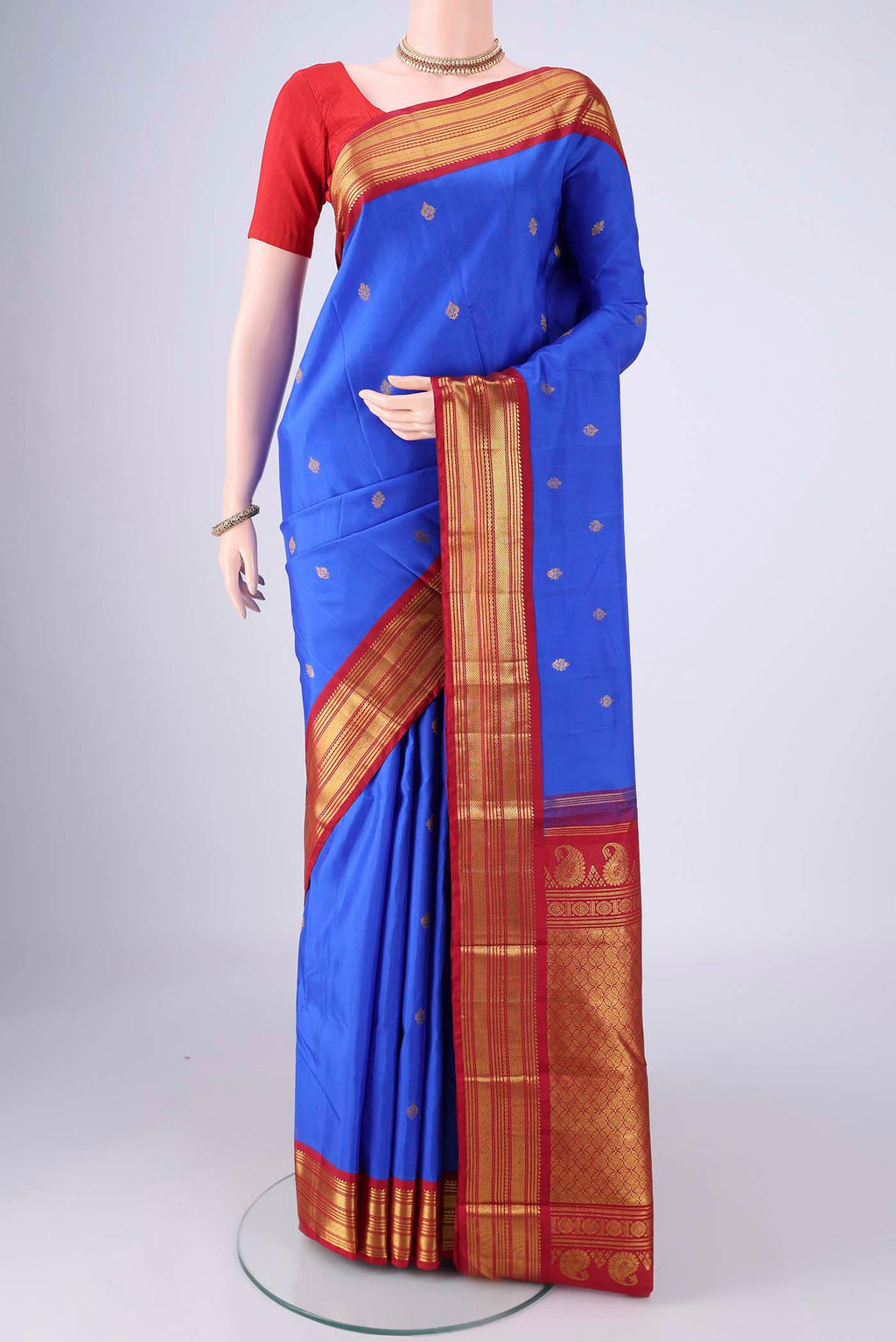 Royal Blue Kanchipuram Silk Saree with Zari Butta on the body and Zari Border.  displayed on a mannequin