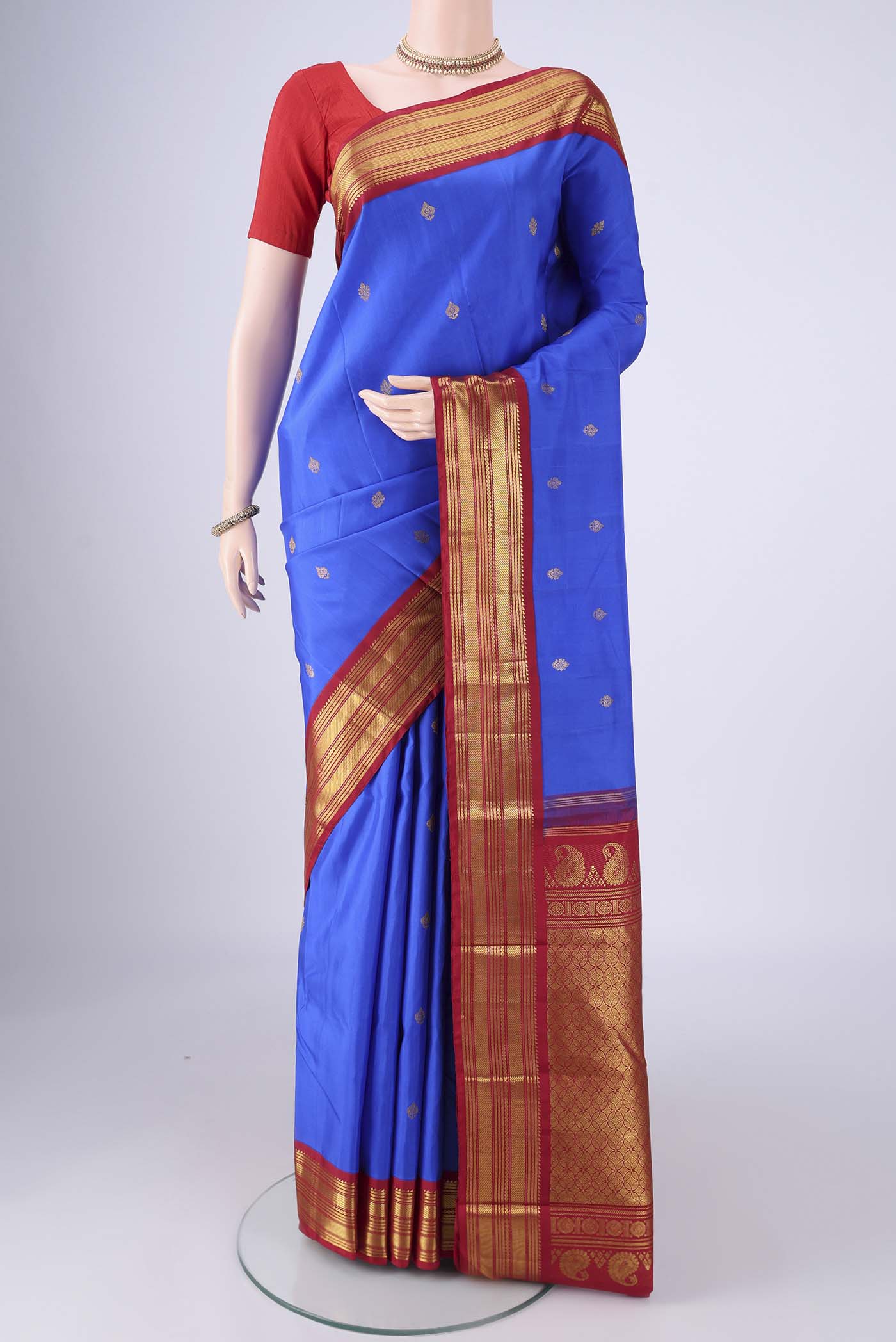 Royal Blue Kanchipuram Silk Saree with Zari Butta on the body and Zari Border.  displayed on a mannequin