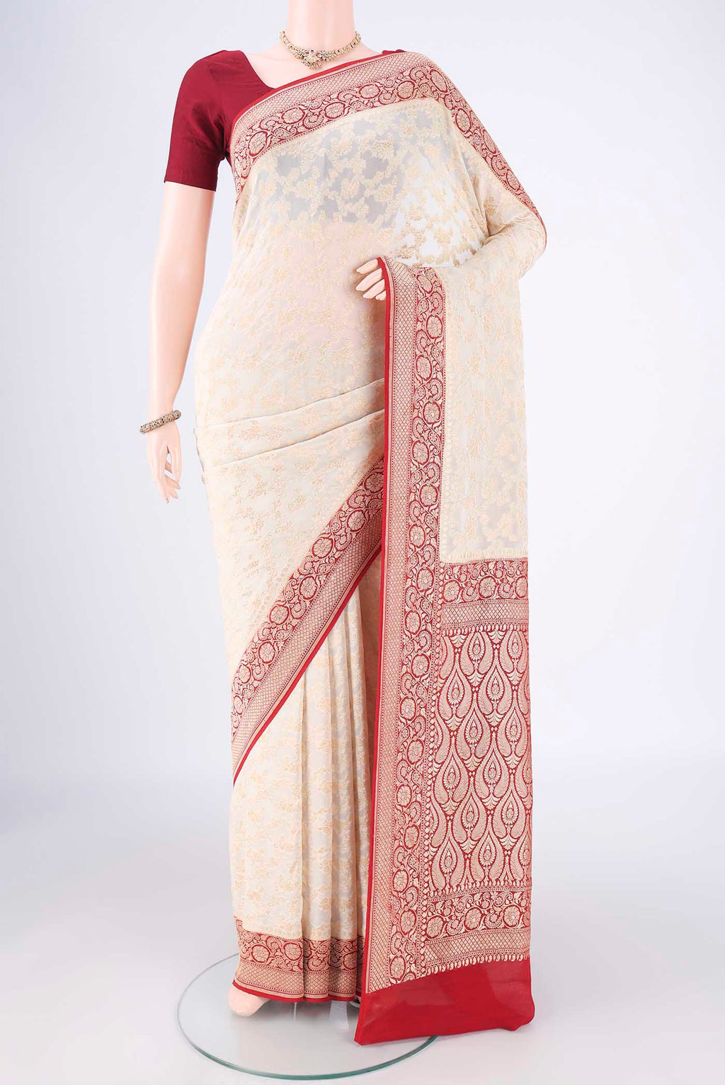 Off White Banarasi Georgette Saree with Zari Brocade on the body and Zari Border.  displayed on a mannequin