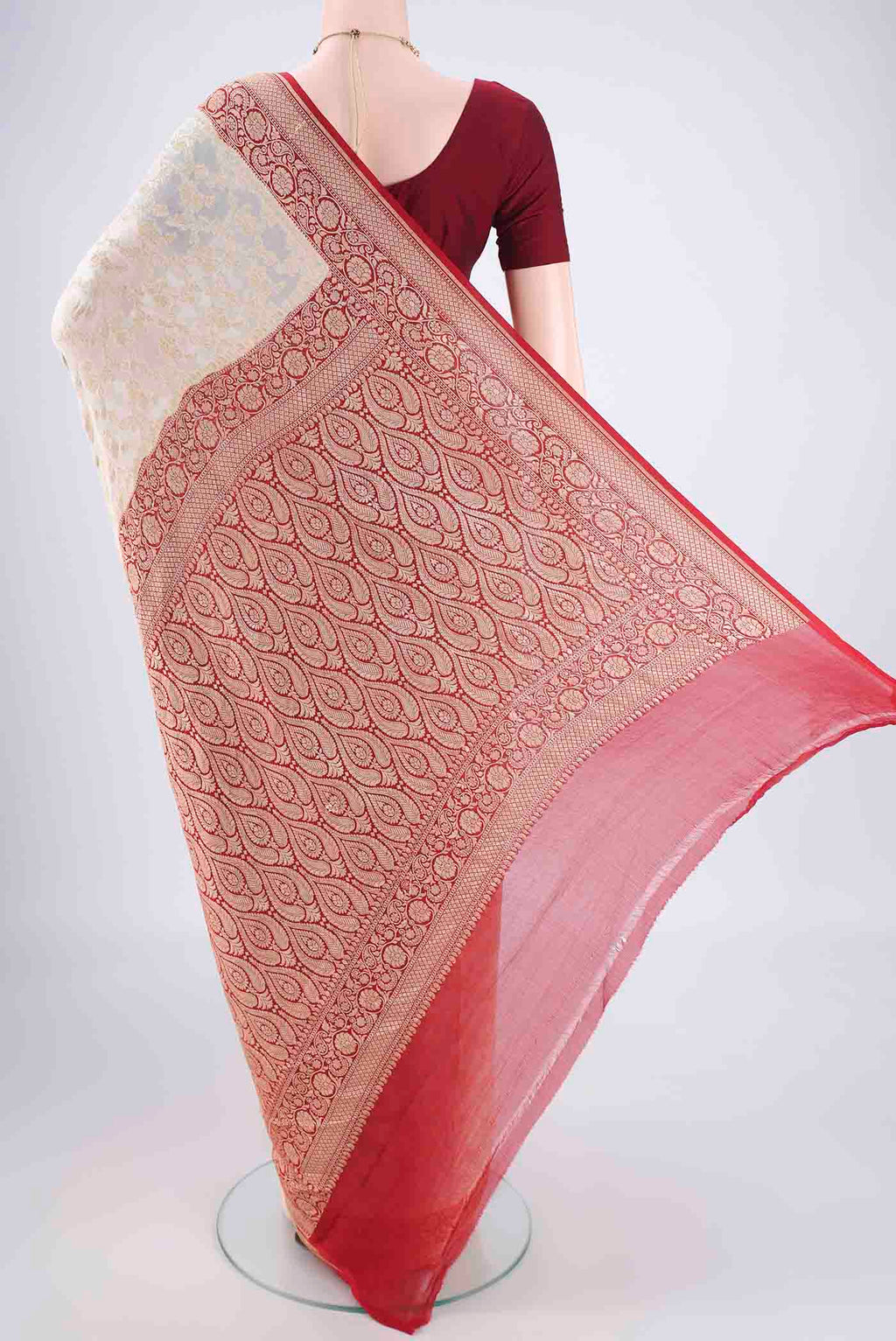 Flat view of Off White Banarasi Georgette Saree with Zari Brocade on the body and Zari Border. 