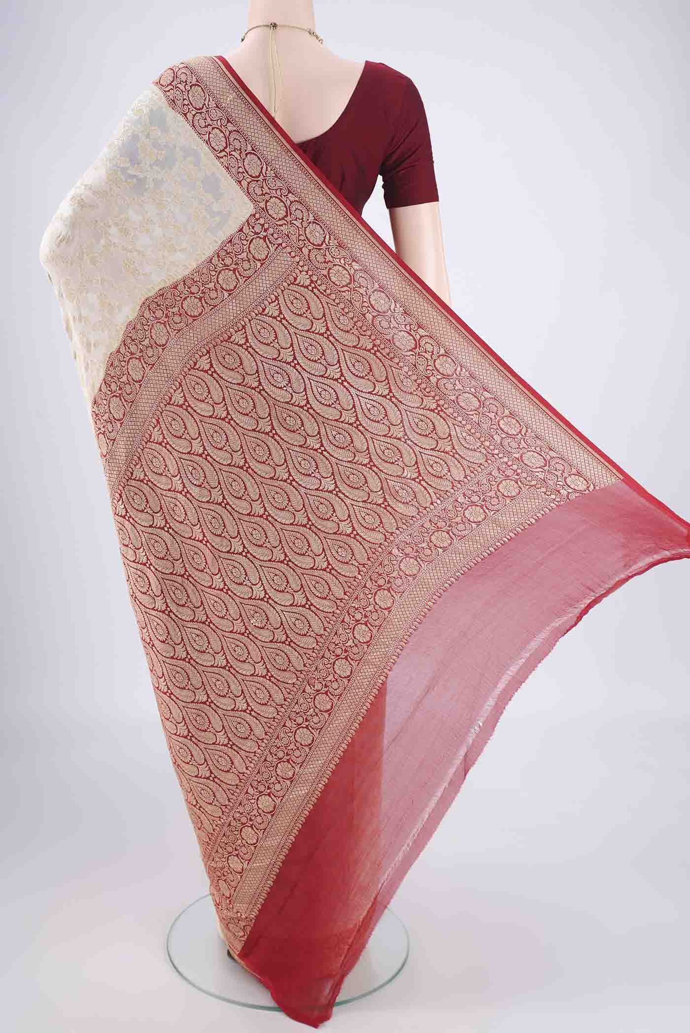 Flat view of Off White Banarasi Georgette Saree with Zari Brocade on the body and Zari Border. 