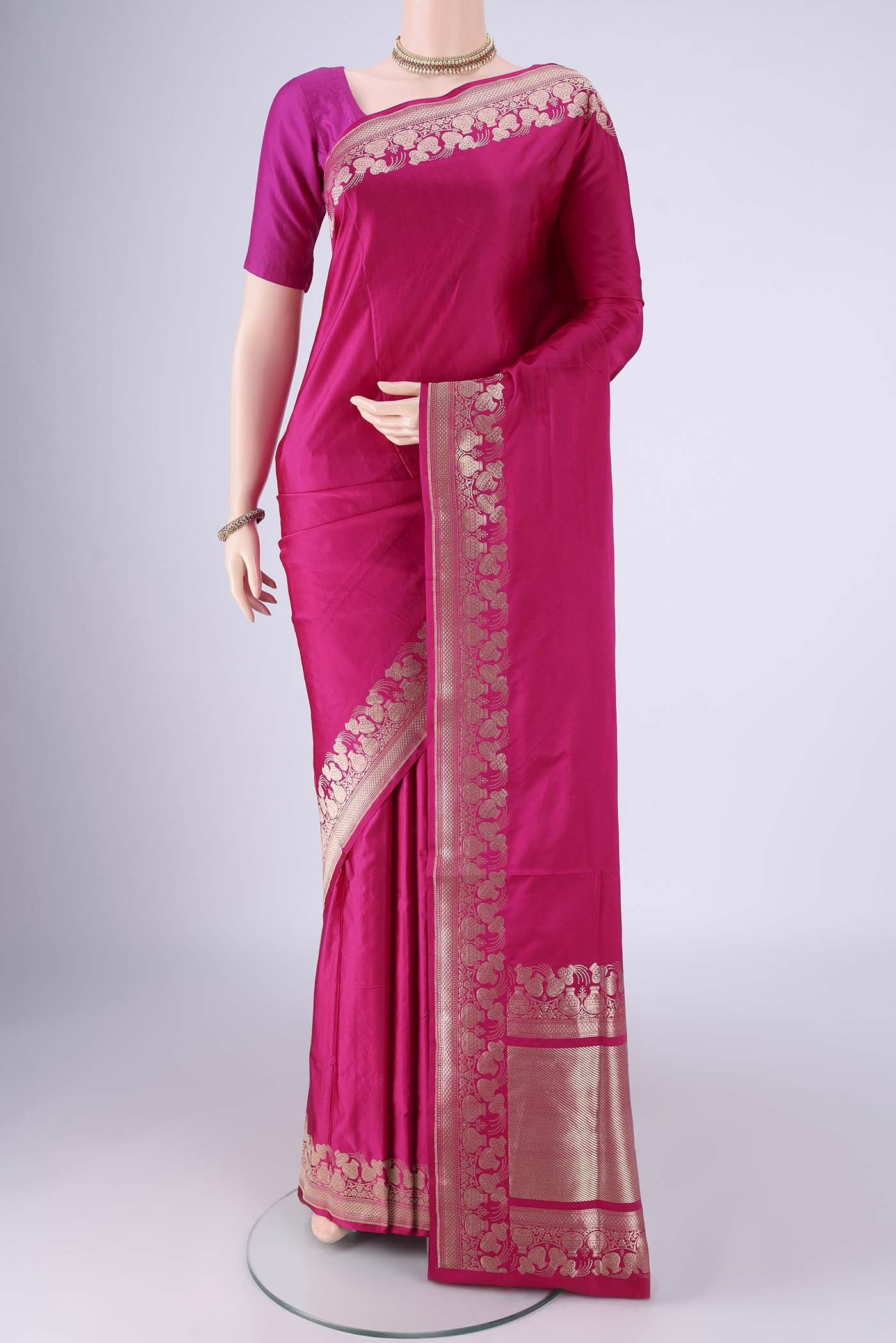 Rani Pink Banarasi Silk Saree with Plain Body and Zari Border.  displayed on a mannequin