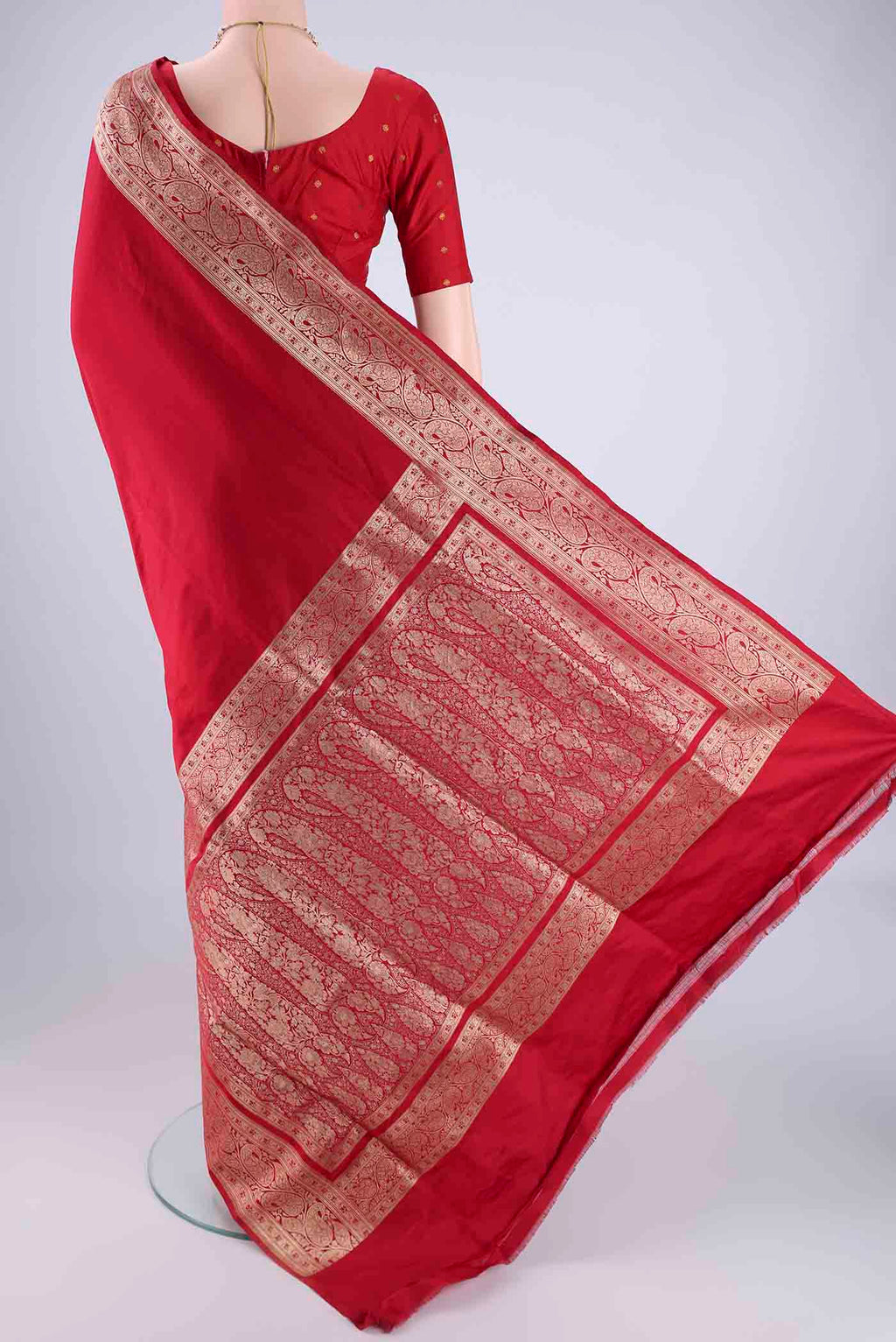 Flat view of Deep Red Banarasi Silk Saree with Plain Body and Zari Border. 