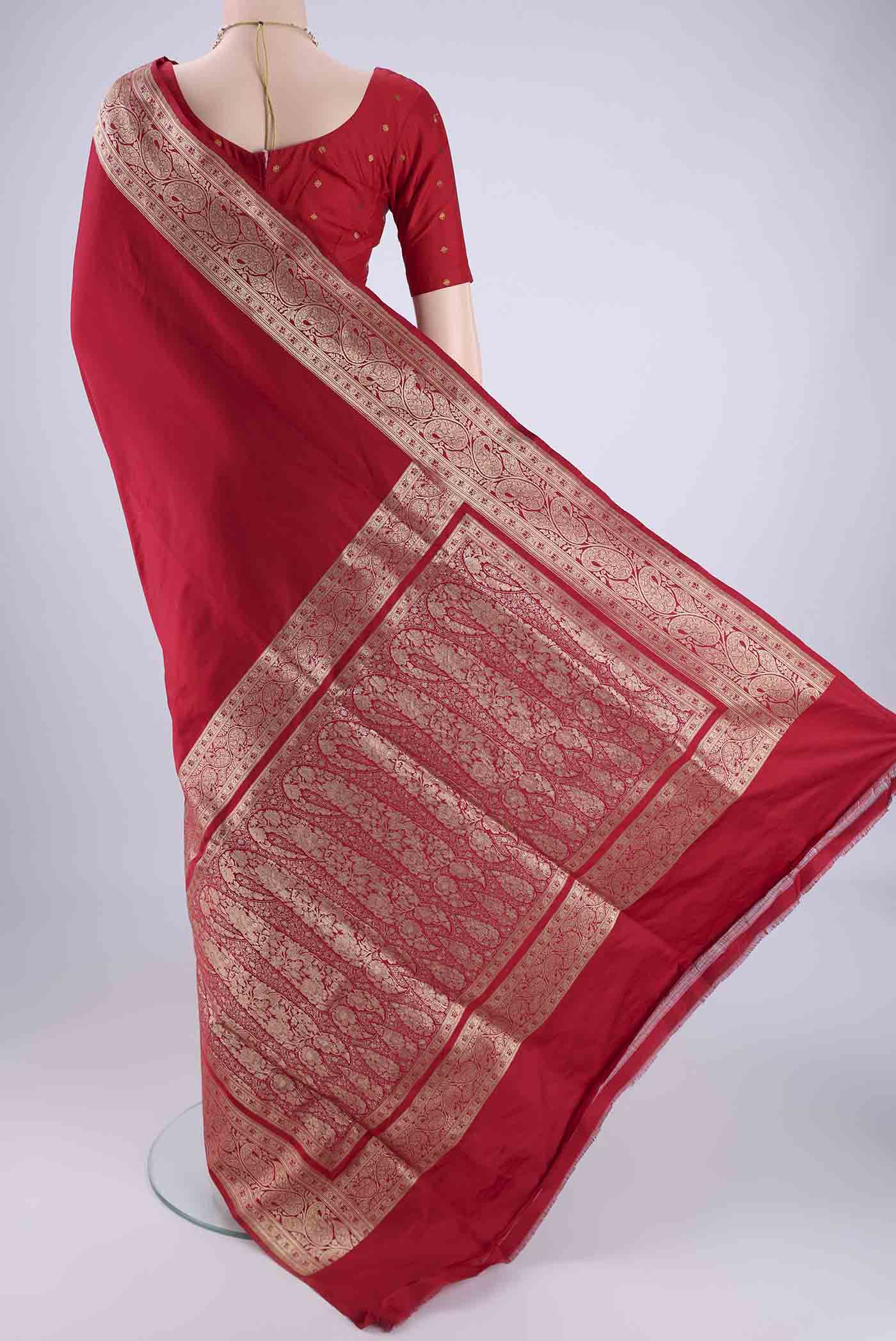 Flat view of Deep Red Banarasi Silk Saree with Plain Body and Zari Border. 