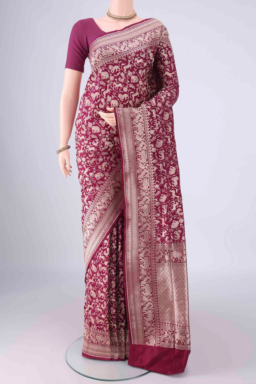 Magenta Banarasi Silk Saree with Zari Brocade on the body and Zari Border.  displayed on a mannequin