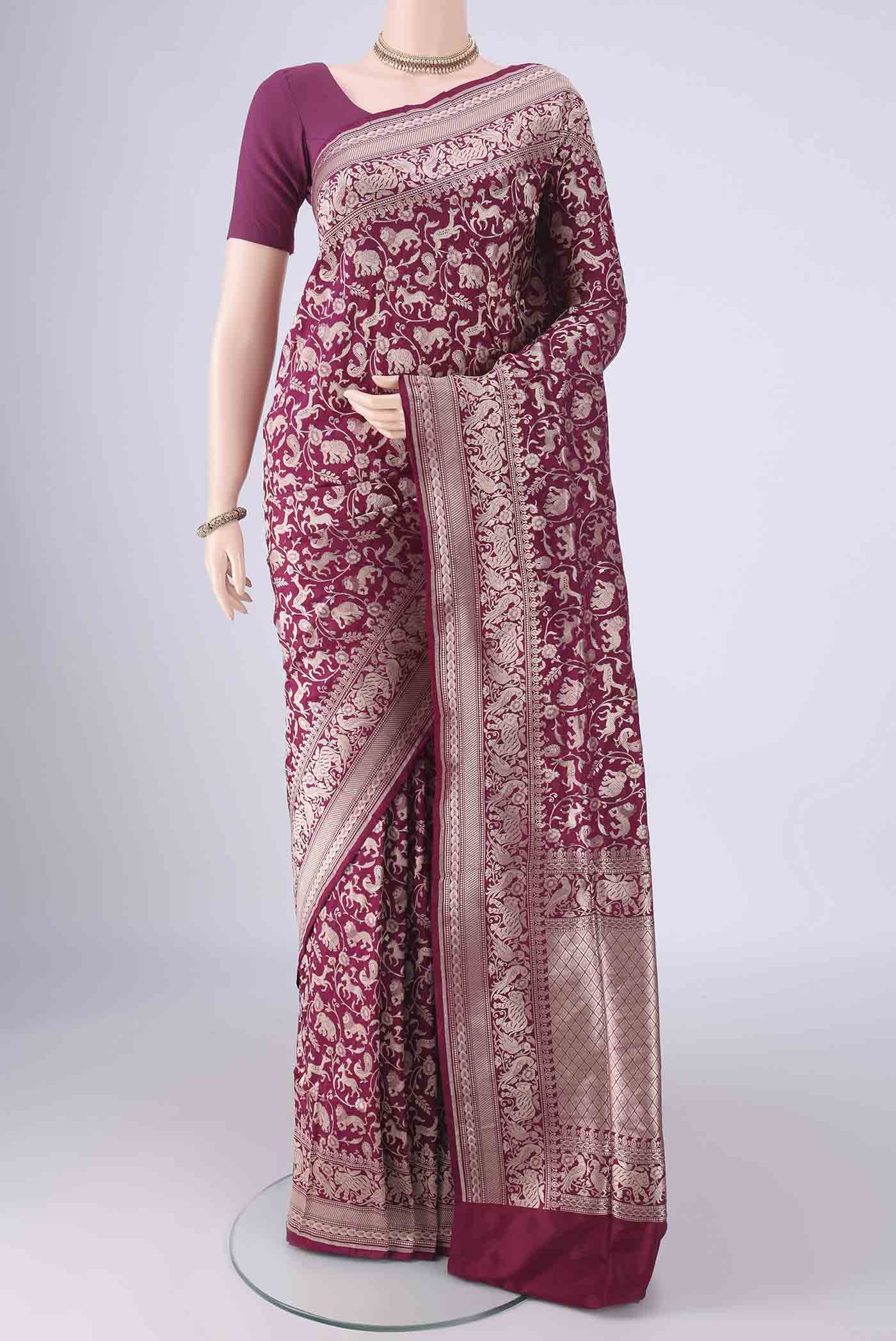 Magenta Banarasi Silk Saree with Zari Brocade on the body and Zari Border.  displayed on a mannequin
