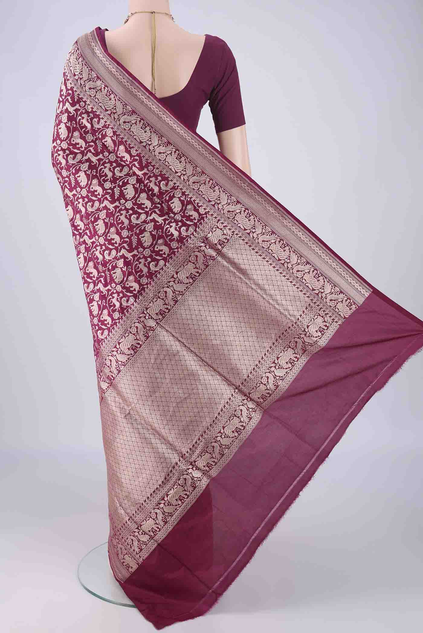 Flat view of Magenta Banarasi Silk Saree with Zari Brocade on the body and Zari Border. 