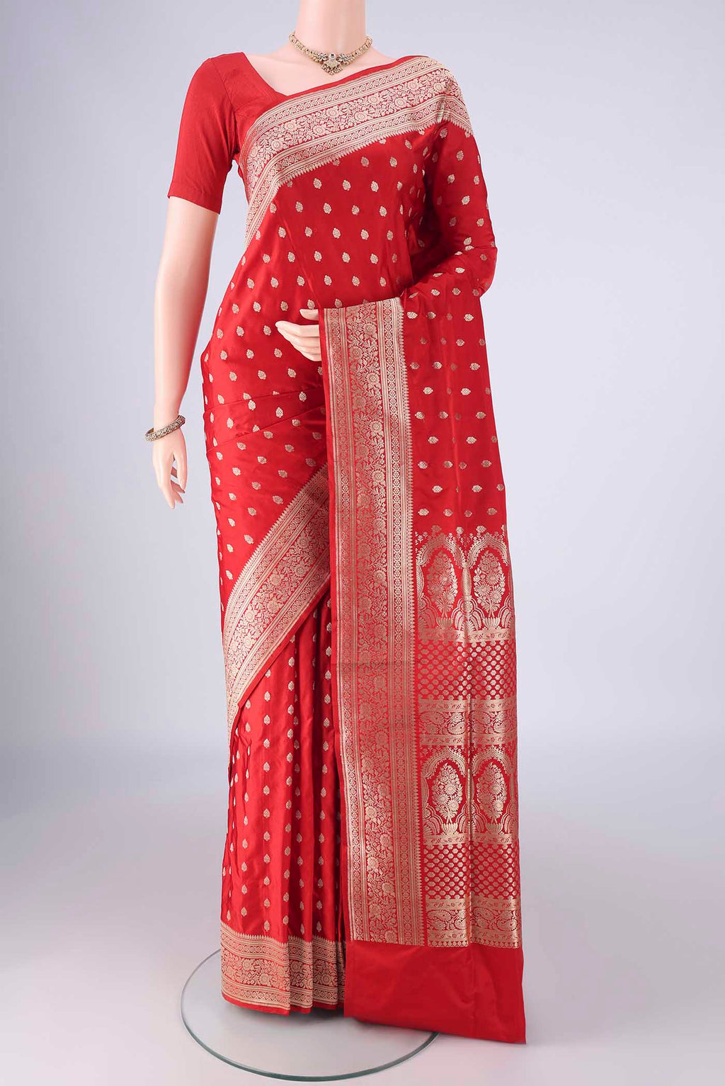 Red Banarasi Silk Saree with Zari Butta on the body and Zari Border.  displayed on a mannequin