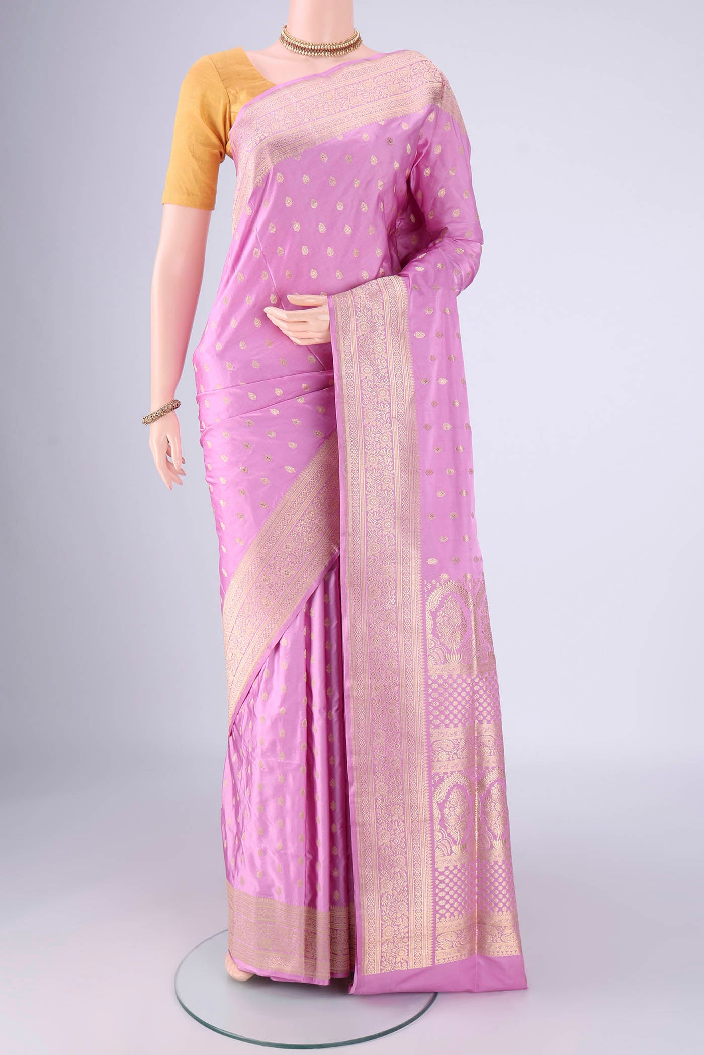 Lilac Banarasi Silk Saree with Zari Butta on the body and Zari Border.  displayed on a mannequin