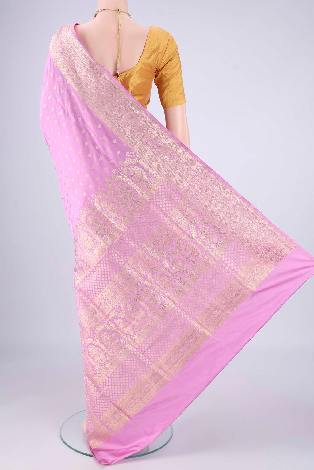 Flat view of Lilac Banarasi Silk Saree with Zari Butta on the body and Zari Border. 