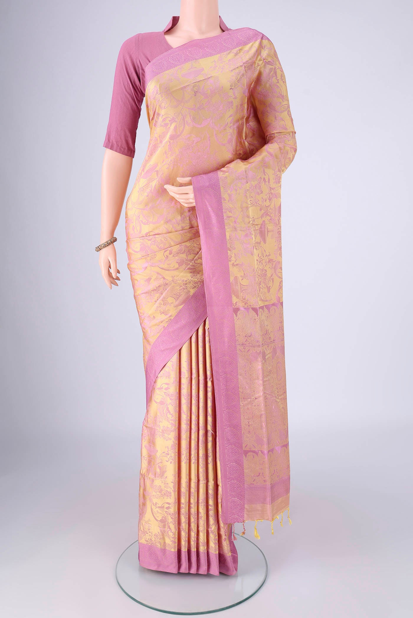 Golden Peach Soft Silk Saree with Jacquard design on the body and Thread Border.  displayed on a mannequin