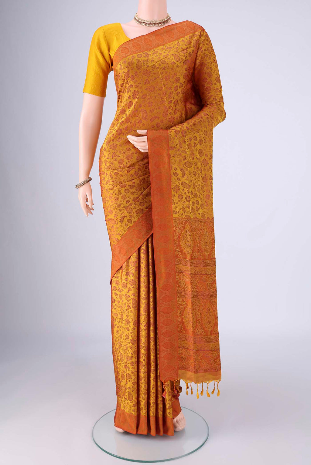 Mustard Soft Silk Saree with Jacquard design on the body and Thread Border.  displayed on a mannequin