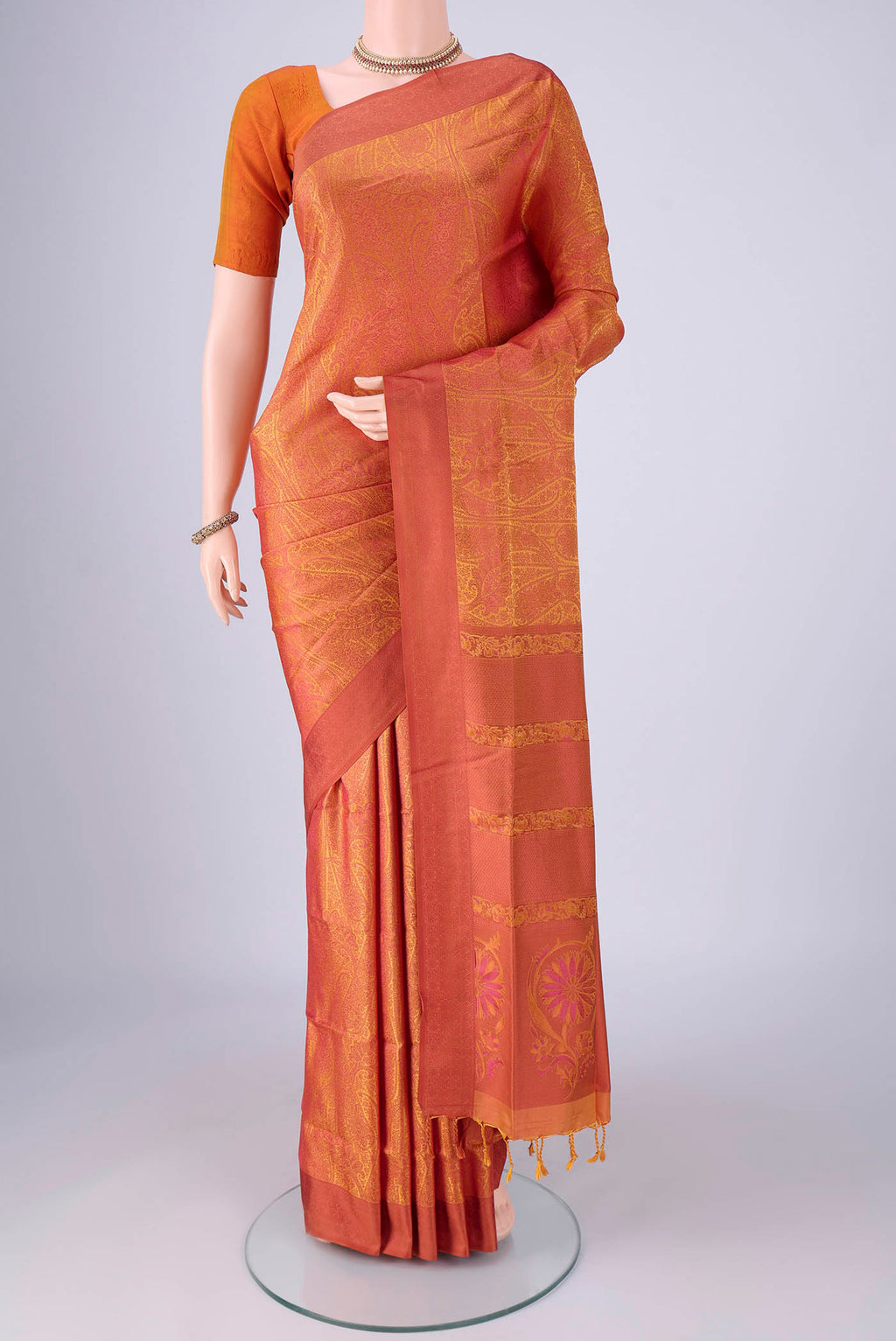 Saffron Soft Silk Saree with Jacquard design on the body and Thread Border.  displayed on a mannequin