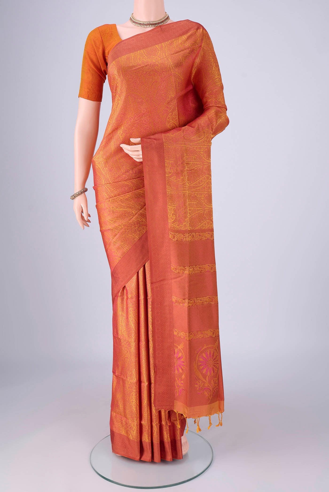 Saffron Soft Silk Saree with Jacquard design on the body and Thread Border.  displayed on a mannequin