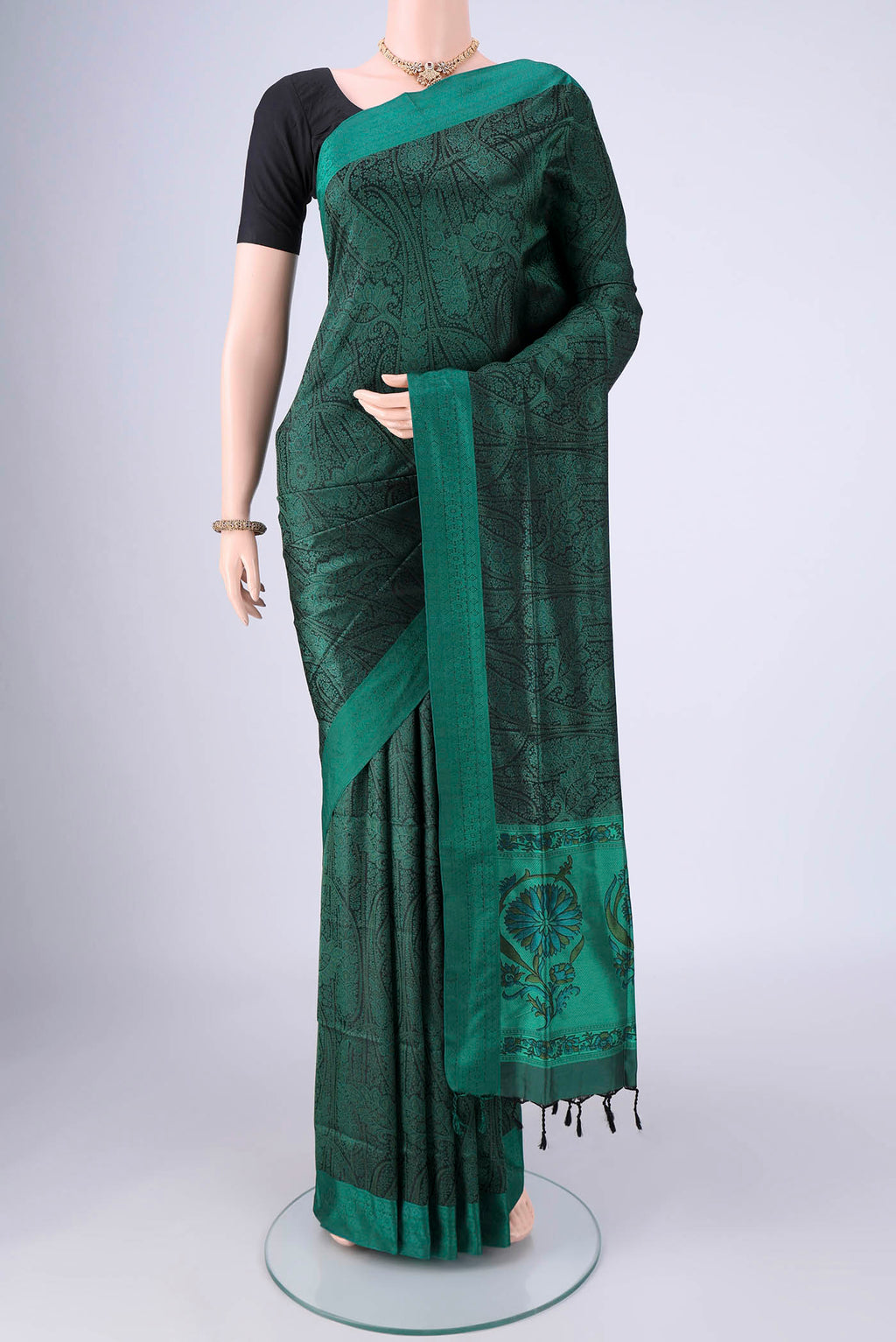Bottle Green Soft Silk Saree with Jacquard design on the body and Thread Border.  displayed on a mannequin
