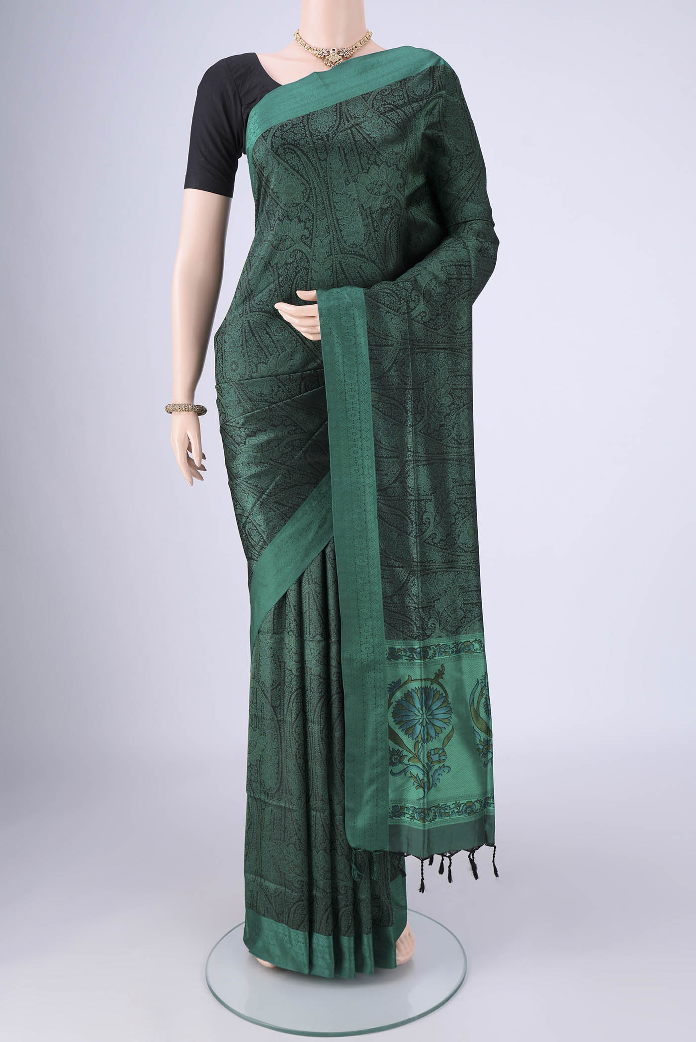 Bottle Green Soft Silk Saree with Jacquard design on the body and Thread Border.  displayed on a mannequin