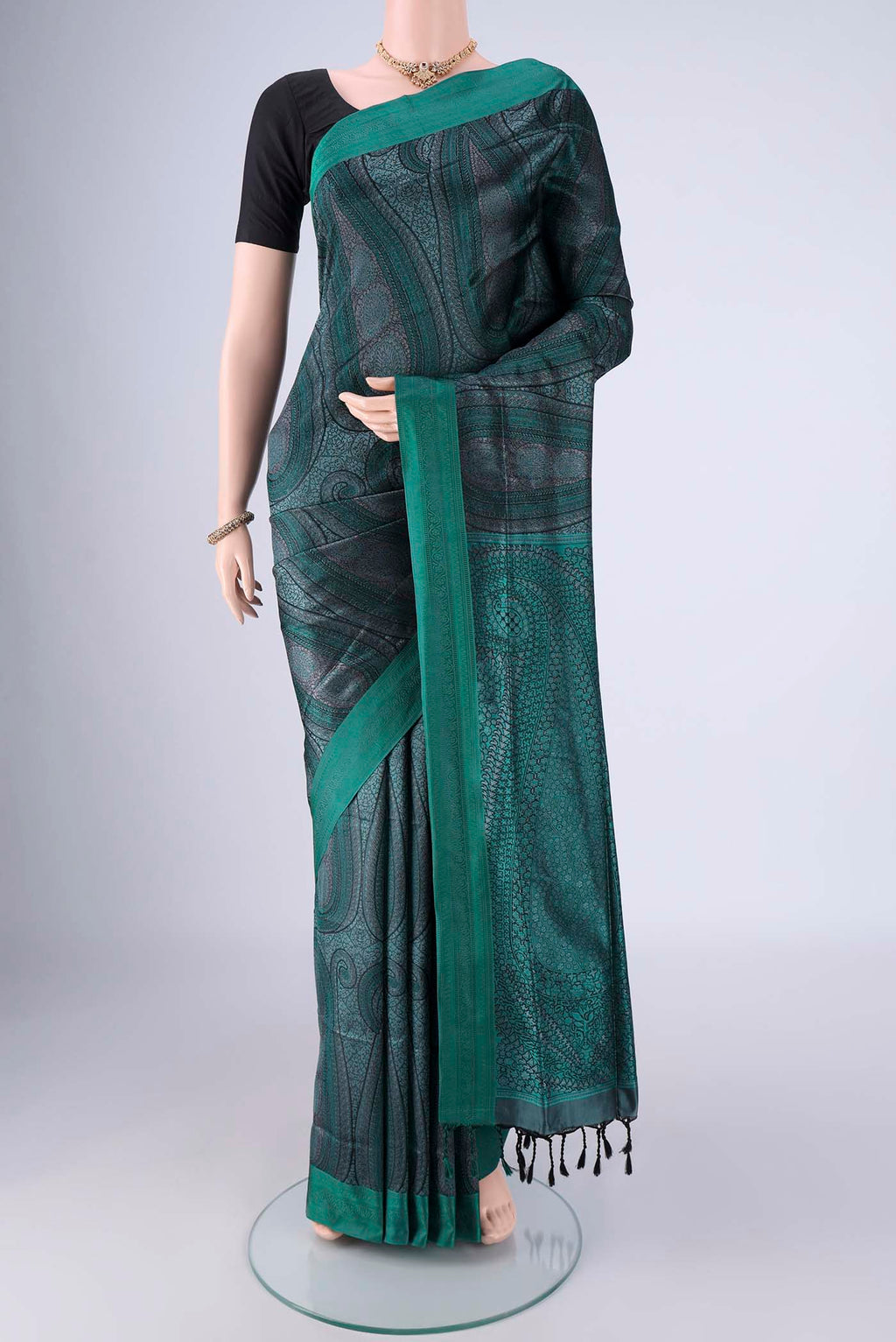 Bottle Green Soft Silk Saree with Jacquard design on the body and Thread Border.  displayed on a mannequin
