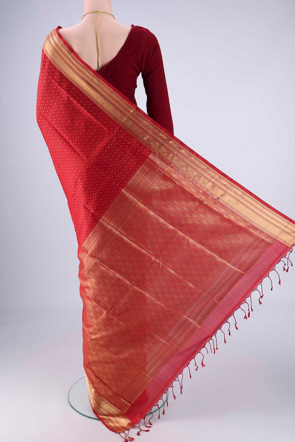 Flat view of Deep Red Soft Silk Saree with Jacquard With Zari Butta on the body and Zari Border. 