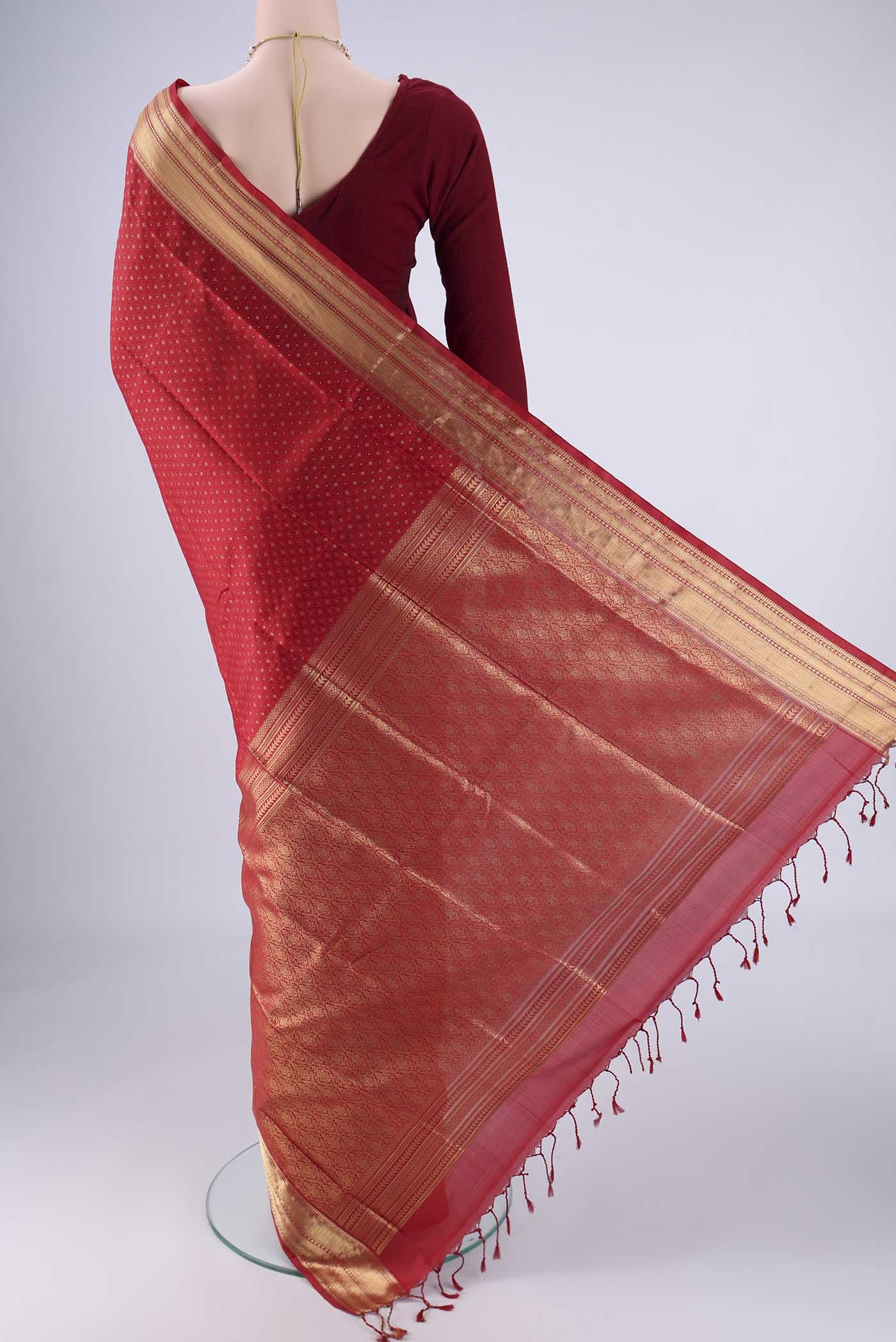 Flat view of Deep Red Soft Silk Saree with Jacquard With Zari Butta on the body and Zari Border. 
