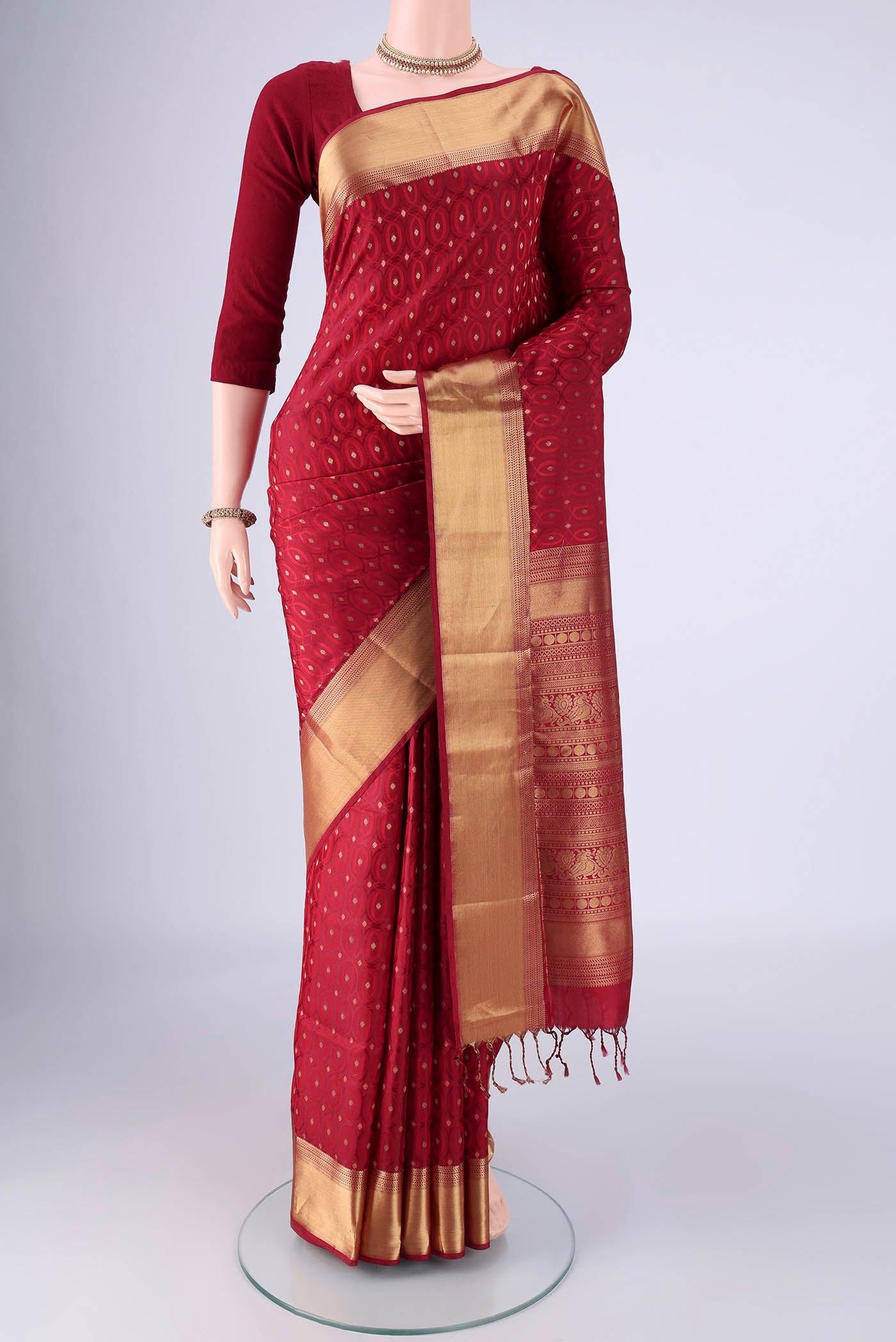 Maroon Soft Silk Saree with Jacquard With Zari Butta on the body and Zari Border.  displayed on a mannequin