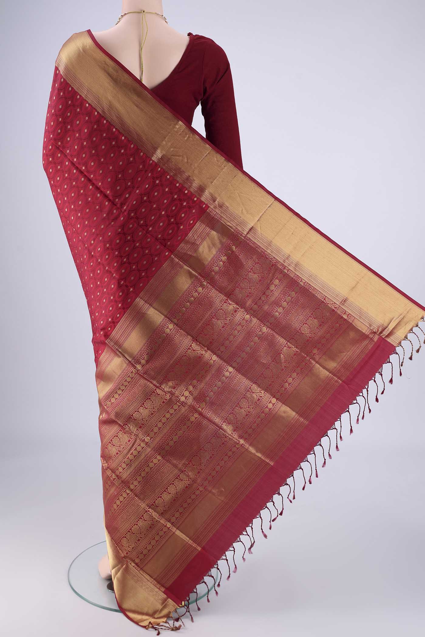 Flat view of Maroon Soft Silk Saree with Jacquard With Zari Butta on the body and Zari Border. 
