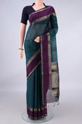 Teal Silk Cotton Saree with Zari Butta on the body and Zari Border.  displayed on a mannequin
