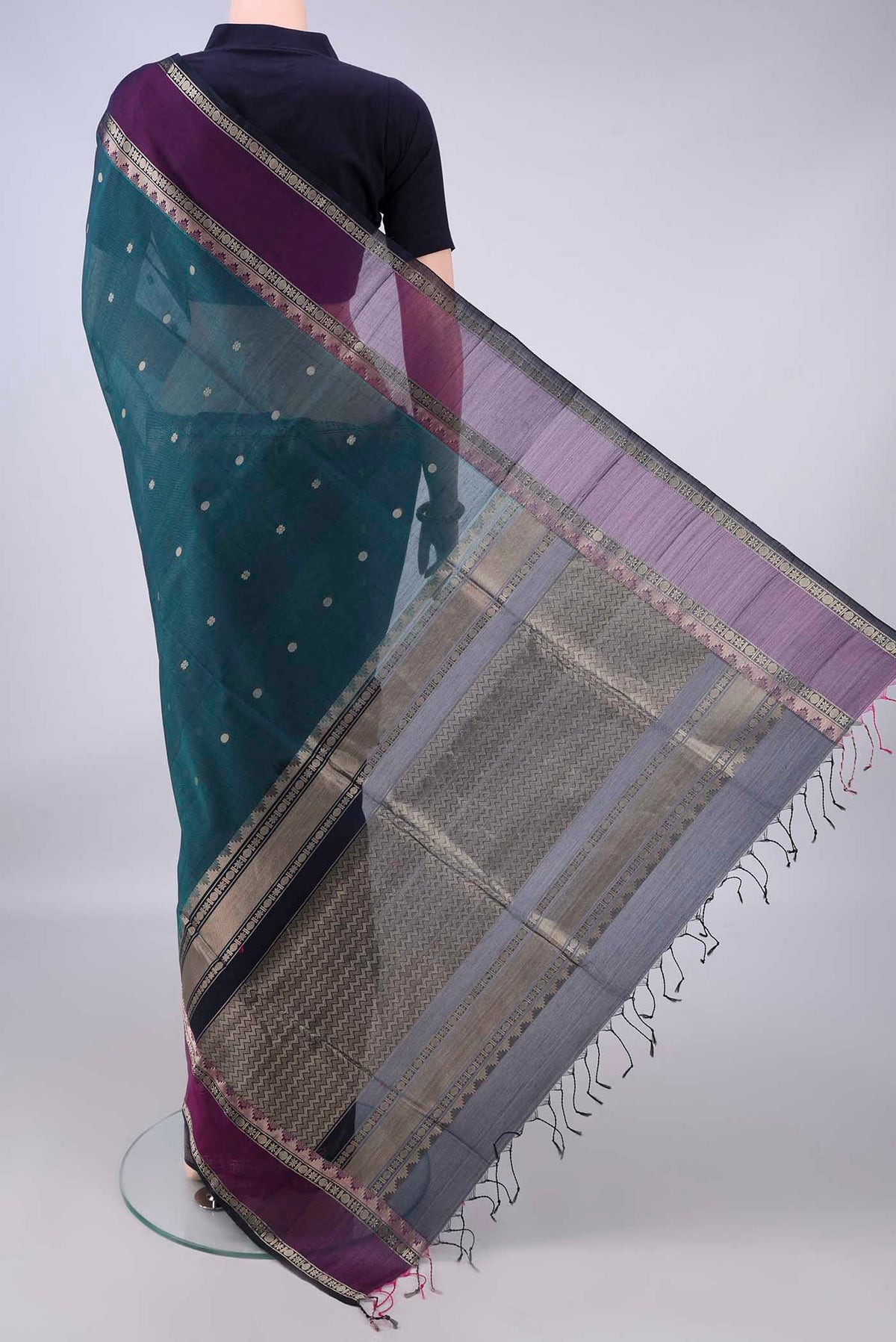 Flat view of Teal Silk Cotton Saree with Zari Butta on the body and Zari Border. 