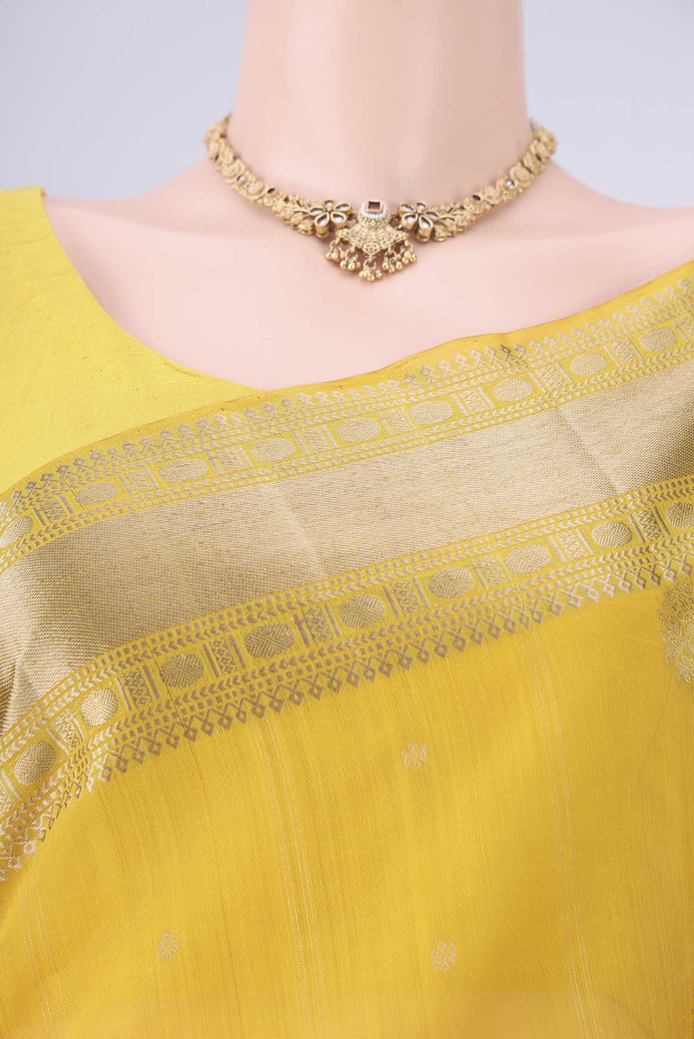 Border image of Yellow Kora Cotton Saree with Zari Butta on the body and Zari Border. 