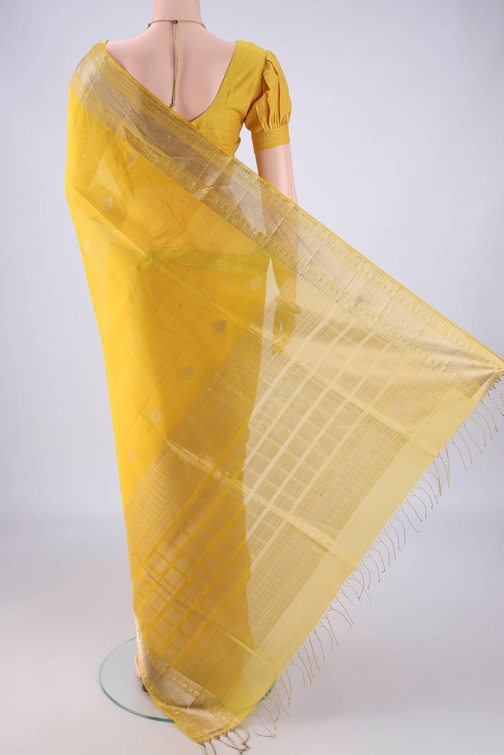 Flat view of Yellow Kora Cotton Saree with Zari Butta on the body and Zari Border. 