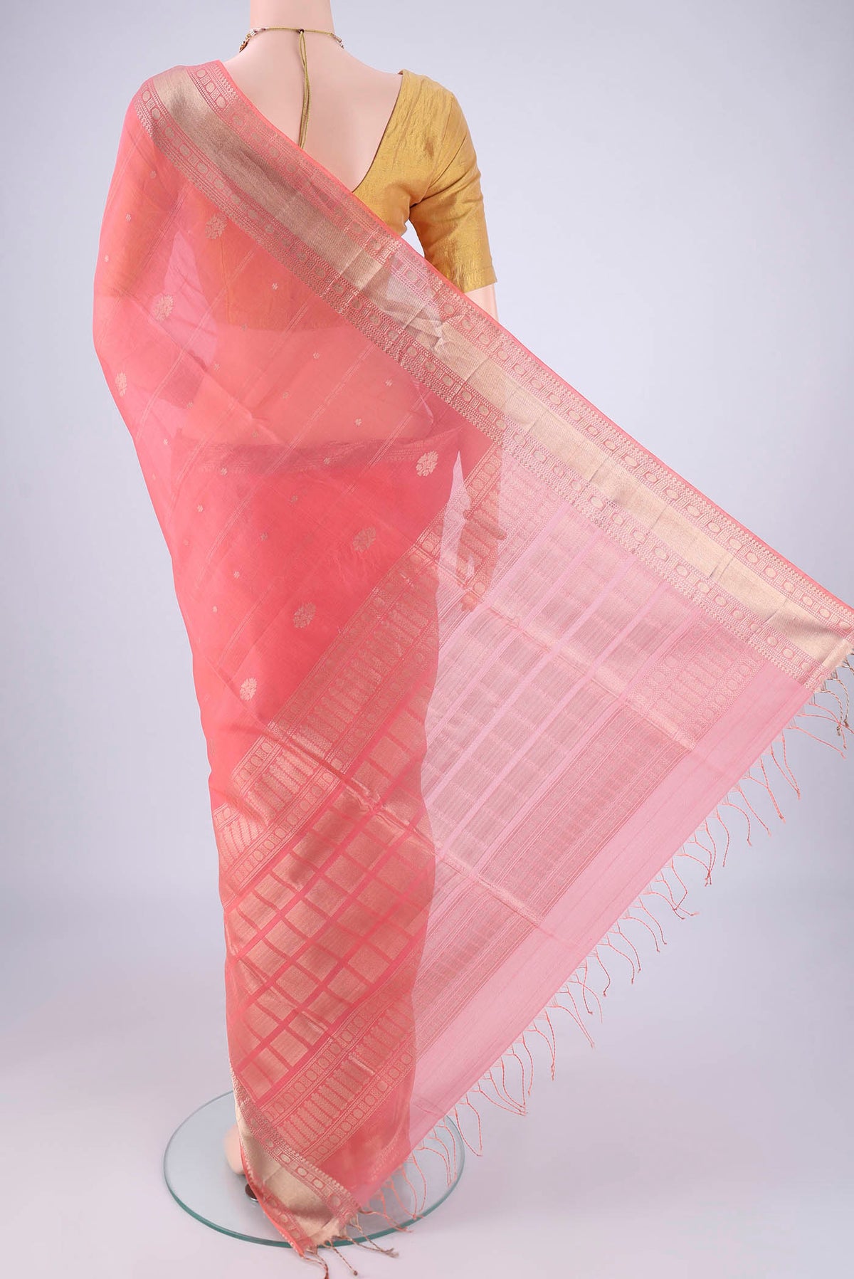 Flat view of Peach Silk Cotton Saree with Zari Butta on the body and Zari Border. 