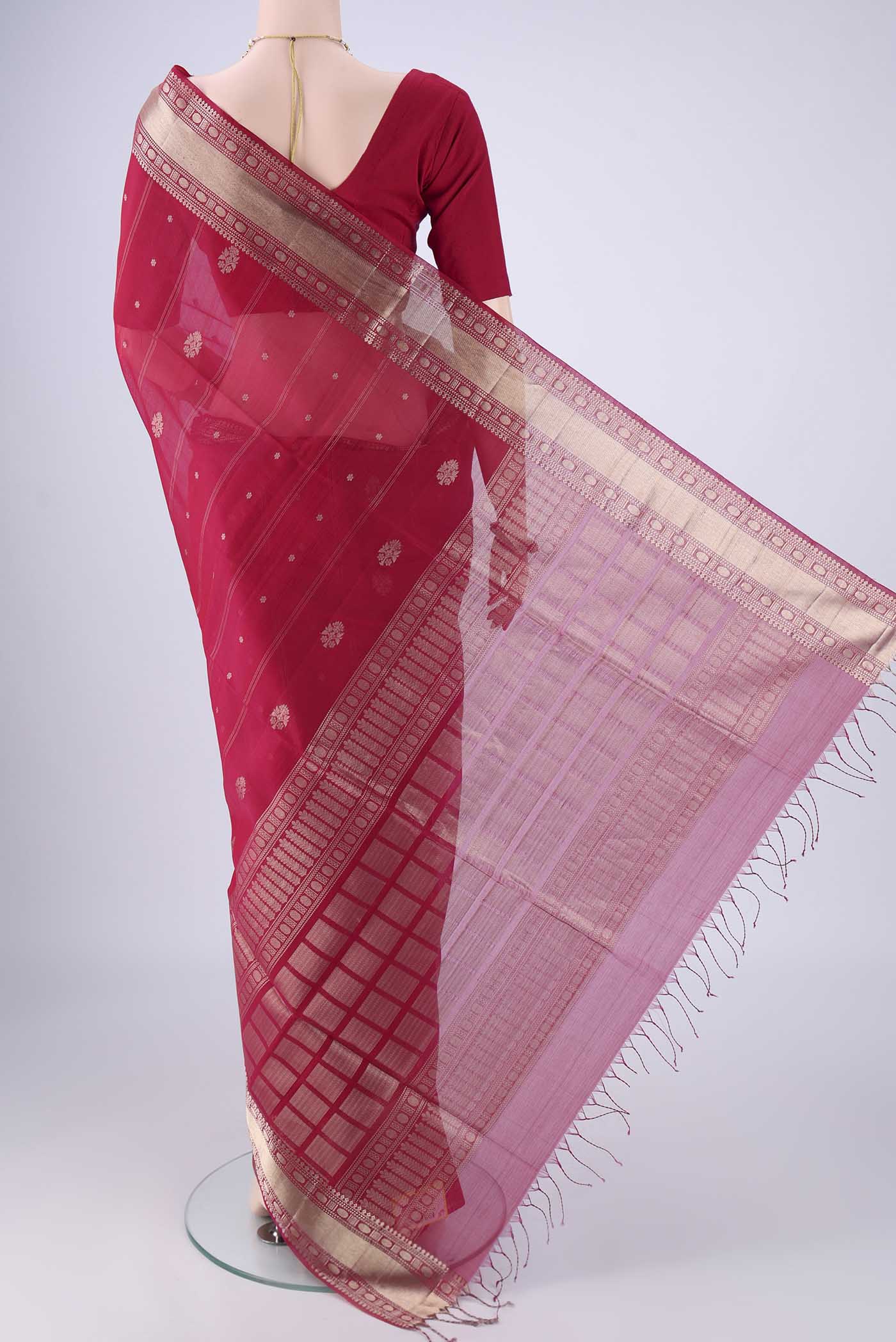 Flat view of Dark Pink Silk Cotton Saree with Zari Butta on the body and Zari Border. 
