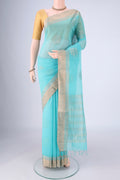 Turquoise Silk Cotton Saree with Zari Butta on the body and Zari Border.  displayed on a mannequin