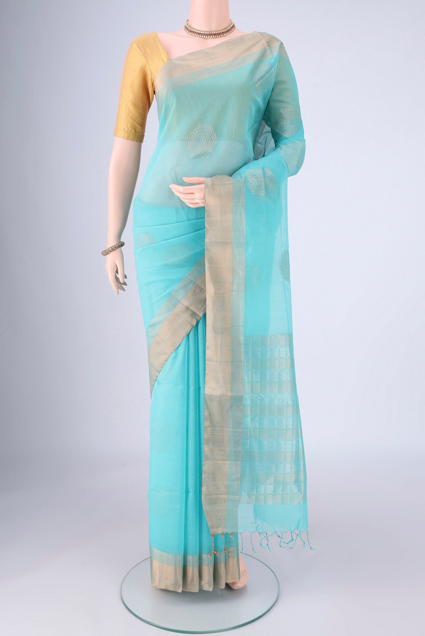 Turquoise Silk Cotton Saree with Zari Butta on the body and Zari Border.  displayed on a mannequin