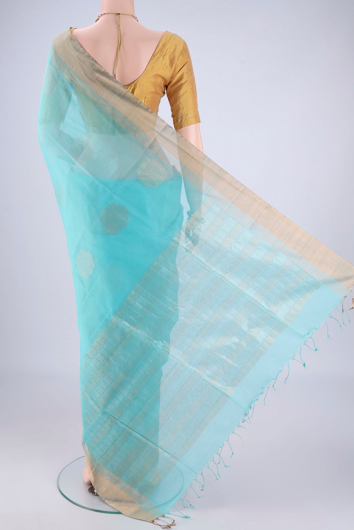 Flat view of Turquoise Silk Cotton Saree with Zari Butta on the body and Zari Border. 