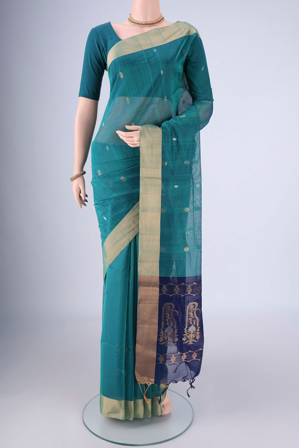 Sea Green Silk Cotton Saree with Zari Butta on the body and Zari Border.  displayed on a mannequin