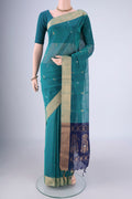 Sea Green Silk Cotton Saree with Zari Butta on the body and Zari Border.  displayed on a mannequin