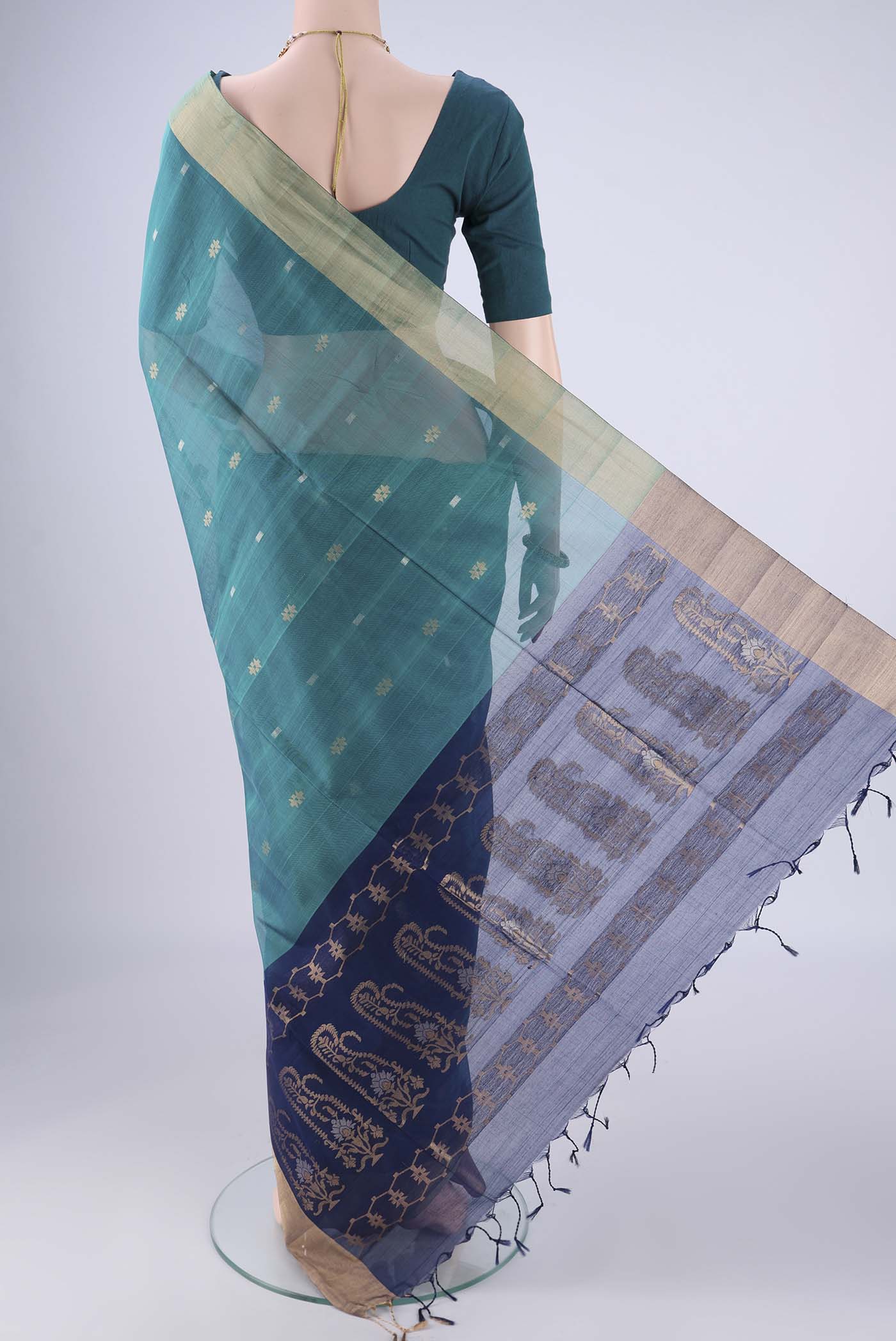 Flat view of Sea Green Silk Cotton Saree with Zari Butta on the body and Zari Border. 