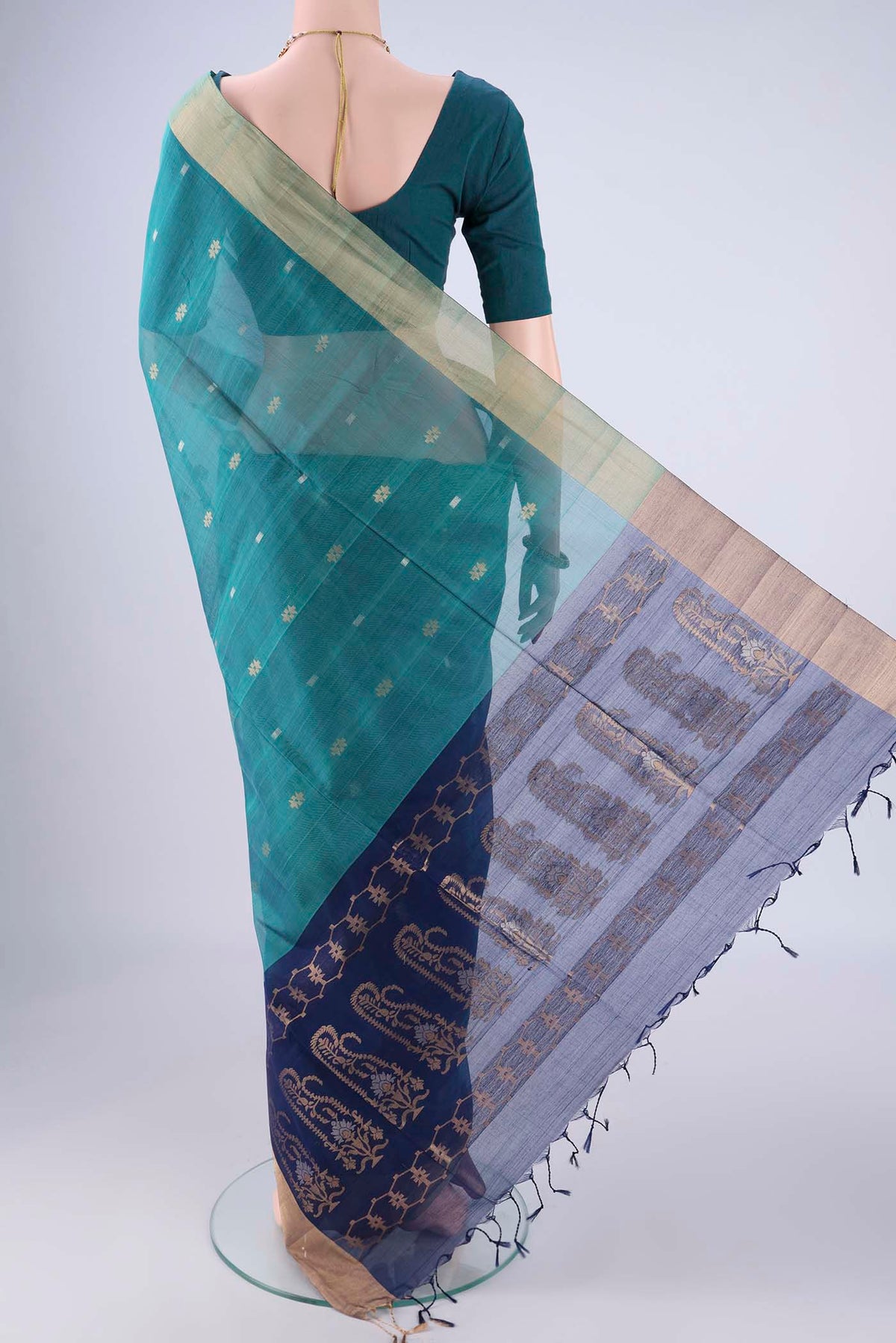 Flat view of Sea Green Silk Cotton Saree with Zari Butta on the body and Zari Border. 