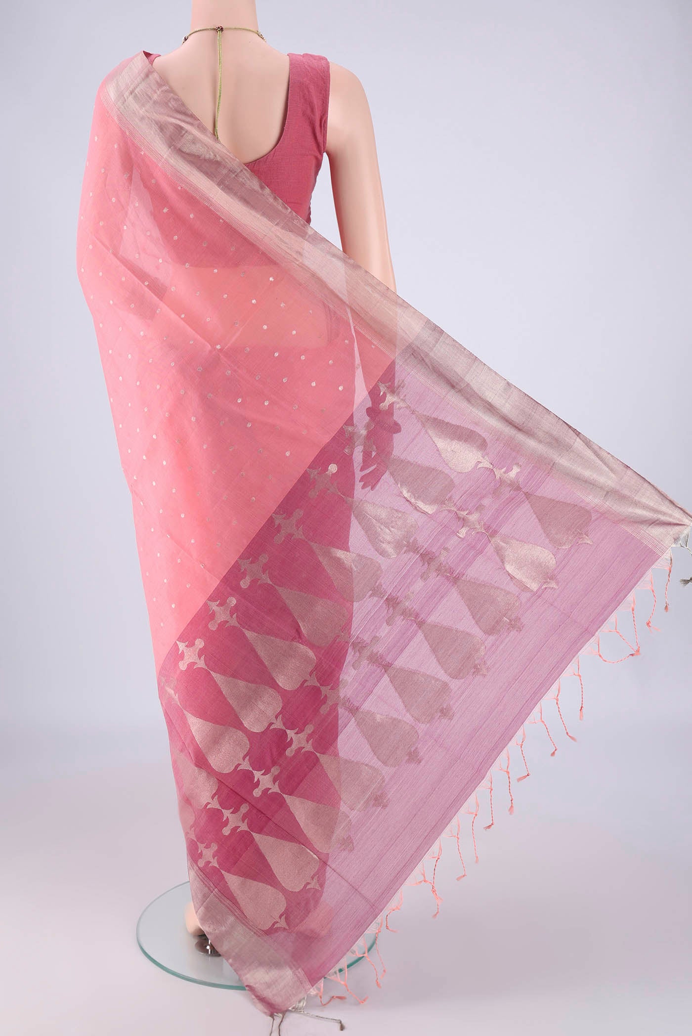 Flat view of Peach Kora Cotton Saree with Zari Butta on the body and Zari Border. 
