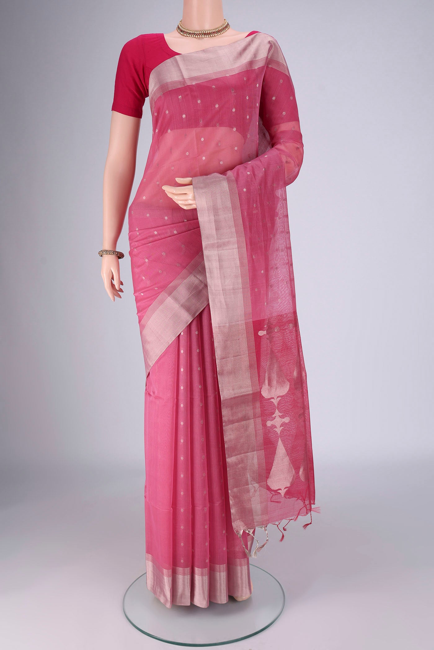 Rose pink Silk Cotton Saree with Zari Butta on the body and Zari Border.  displayed on a mannequin