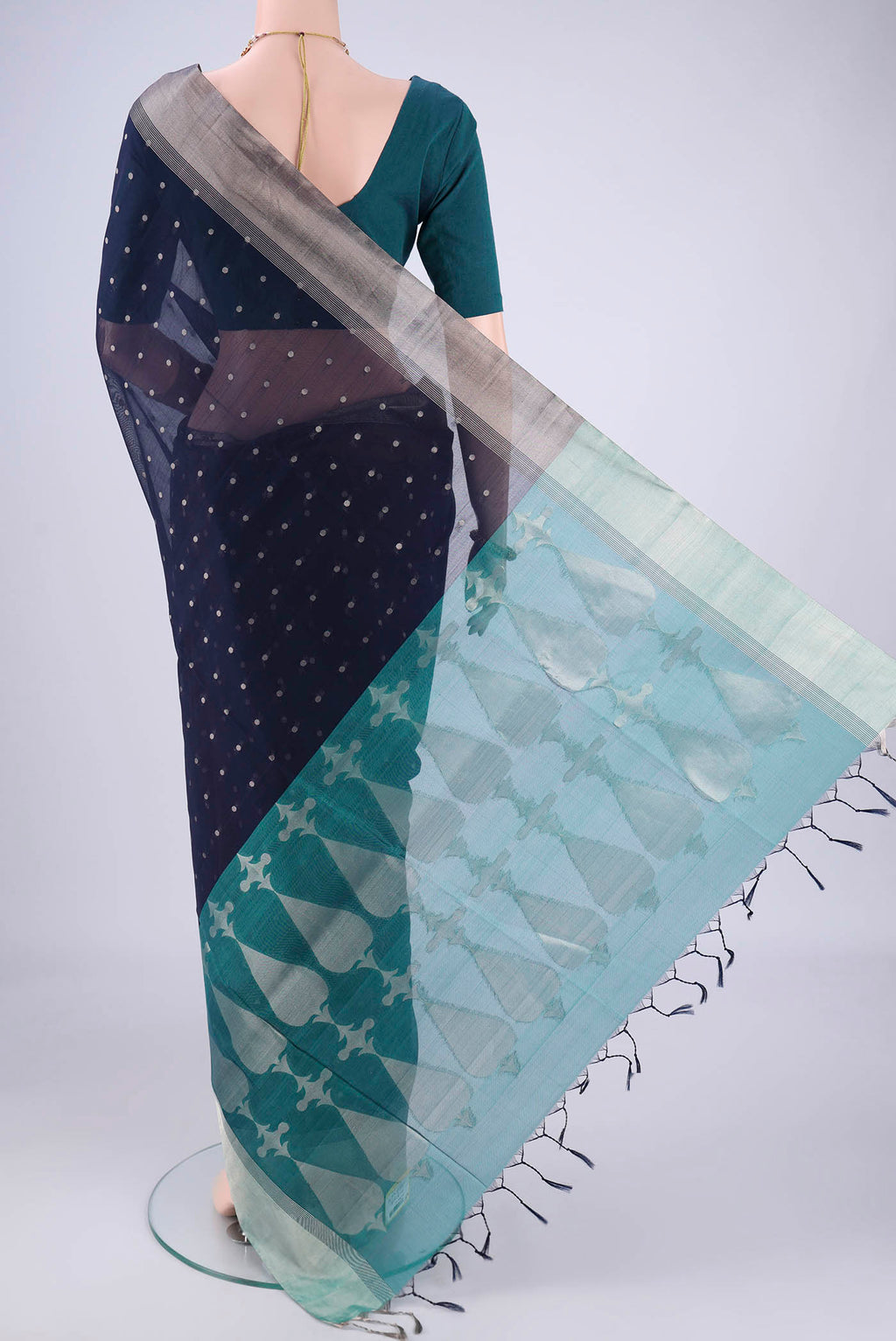 Flat view of Navy Blue Silk Cotton Saree with Zari Butta on the body and Zari Border. 