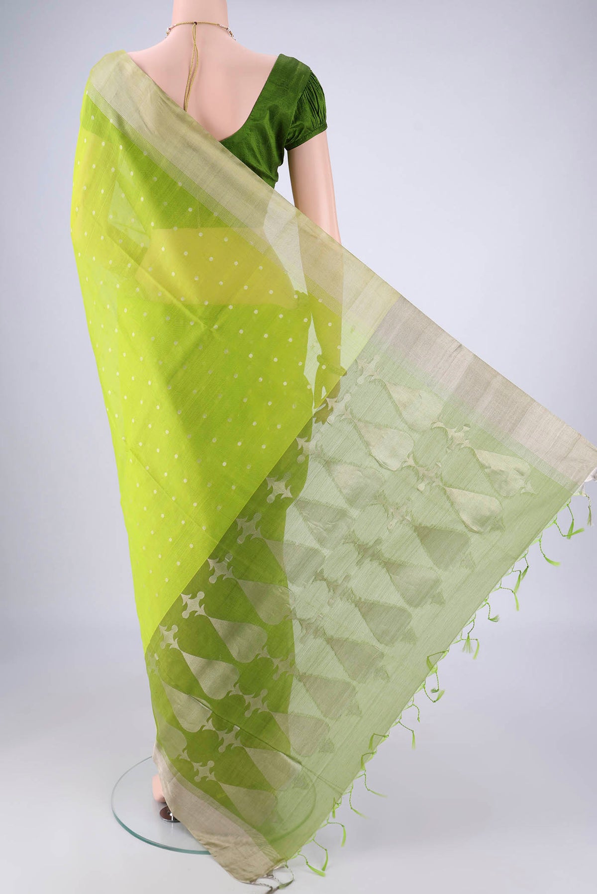 Flat view of Parrot Green Silk Cotton Saree with Zari Butta on the body and Zari Border. 