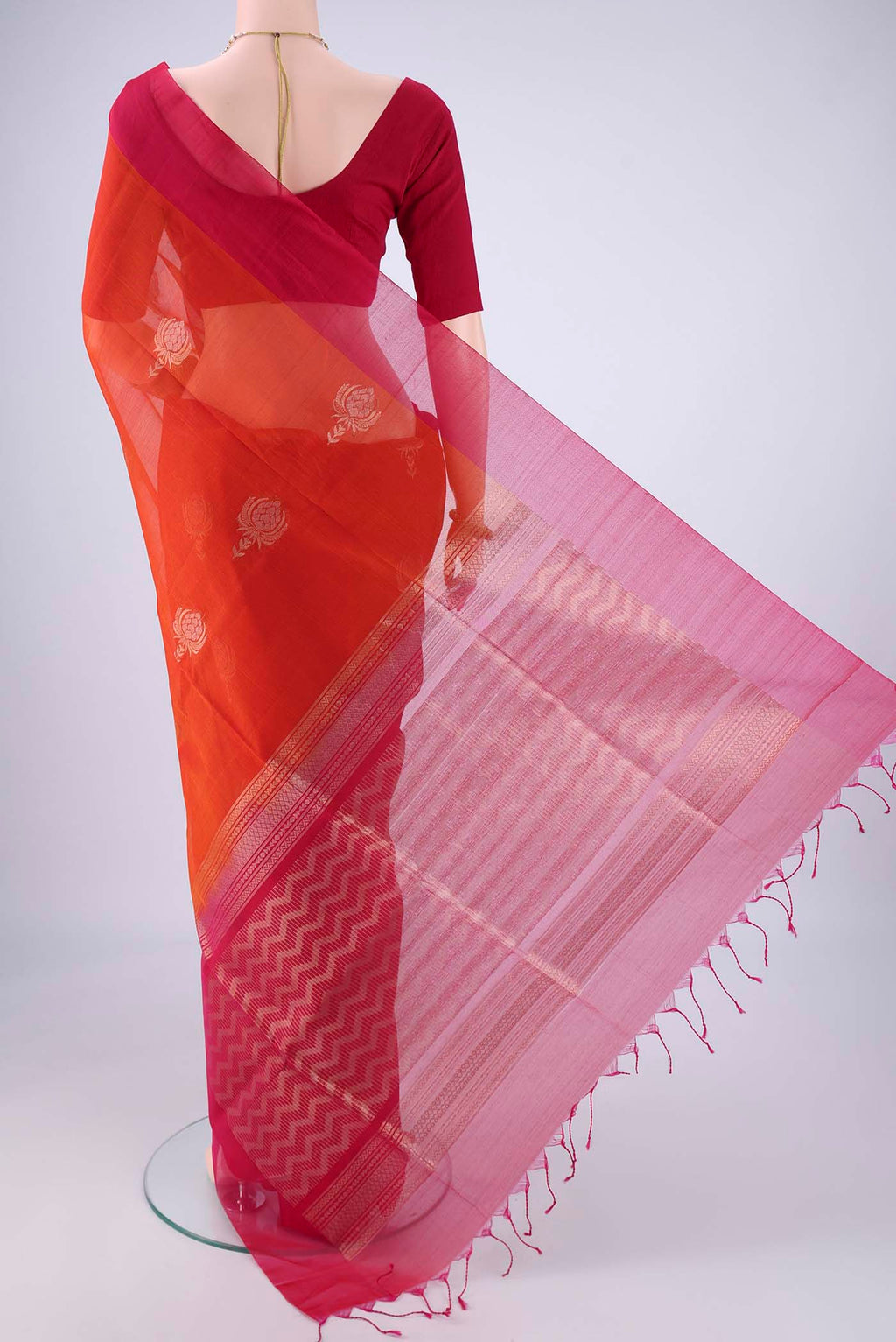 Flat view of Rust Kora Cotton Saree with Zari Butta on the body and Plain Border. 