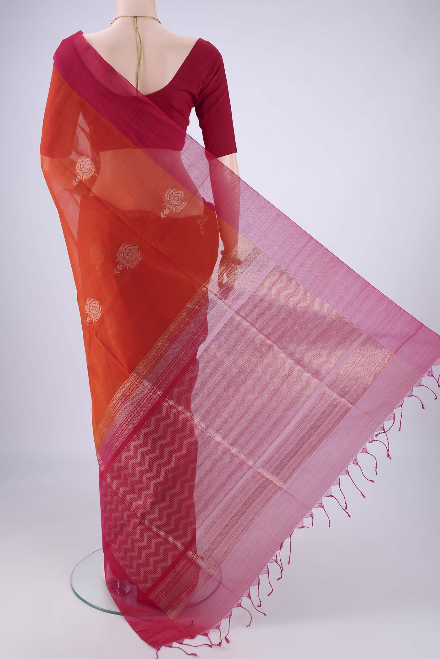 Flat view of Rust Kora Cotton Saree with Zari Butta on the body and Plain Border. 