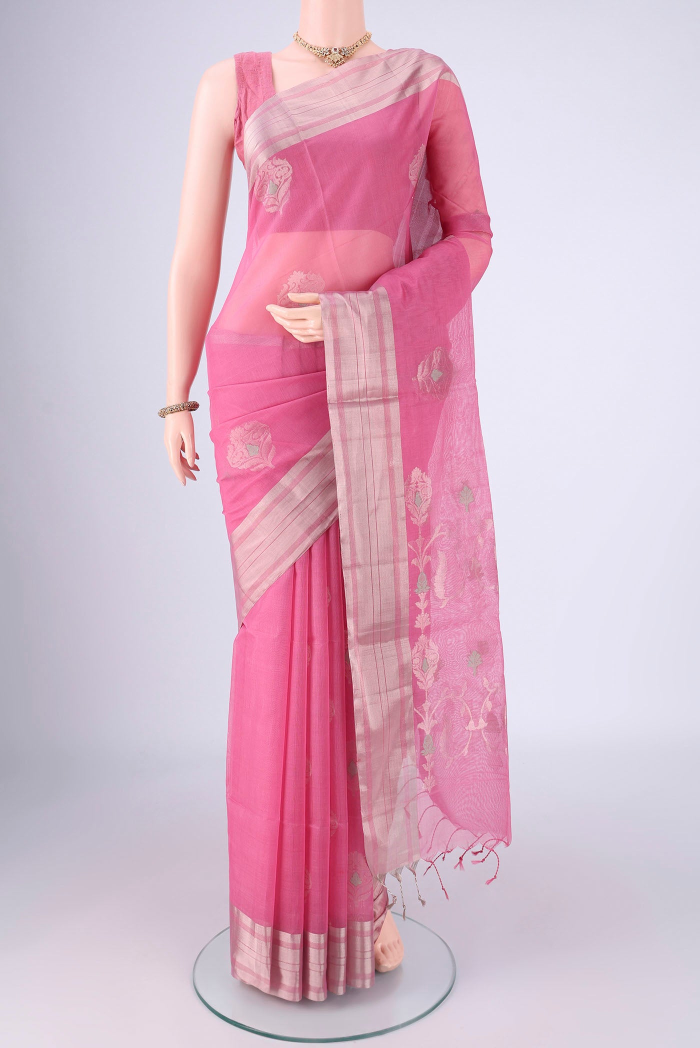 Pink Silk Cotton Saree with Zari Butta on the body and Zari Border.  displayed on a mannequin