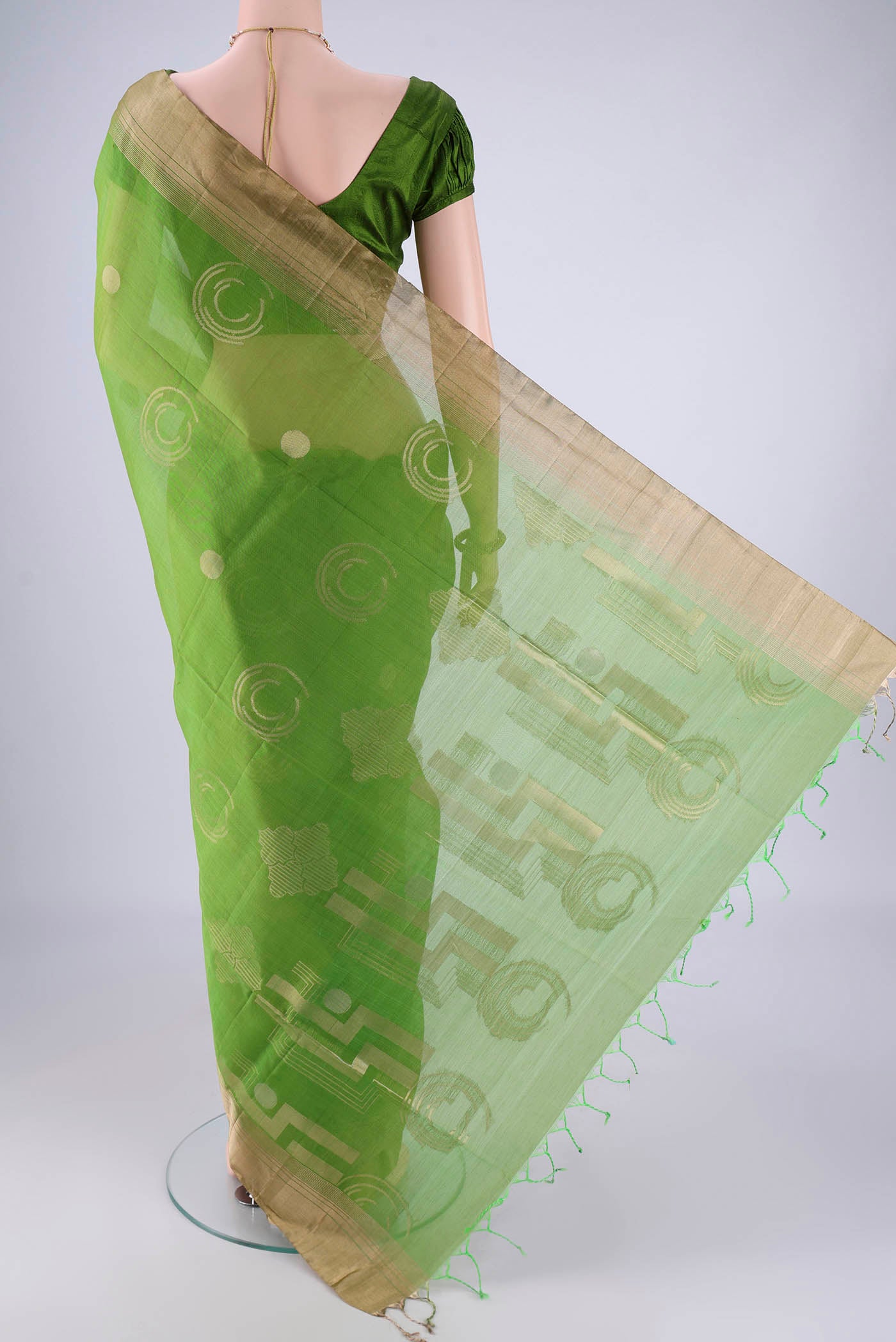 Flat view of Green Silk Cotton Saree with Zari Butta on the body and Zari Border. 