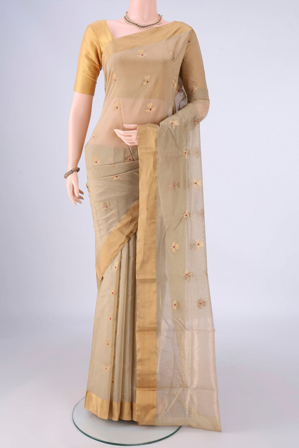 Beige Chanderi Silk Cotton Saree with Zari And Thread Butta on the body and Zari Border.  displayed on a mannequin