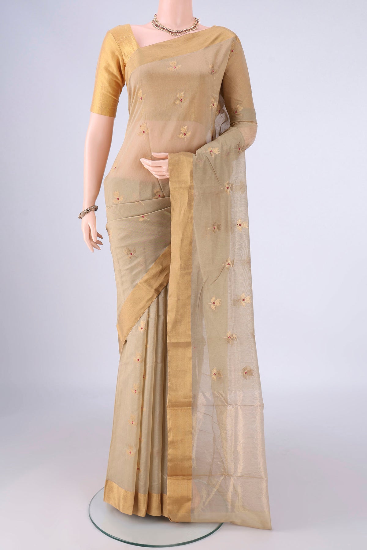 Beige Chanderi Silk Cotton Saree with Zari And Thread Butta on the body and Zari Border.  displayed on a mannequin